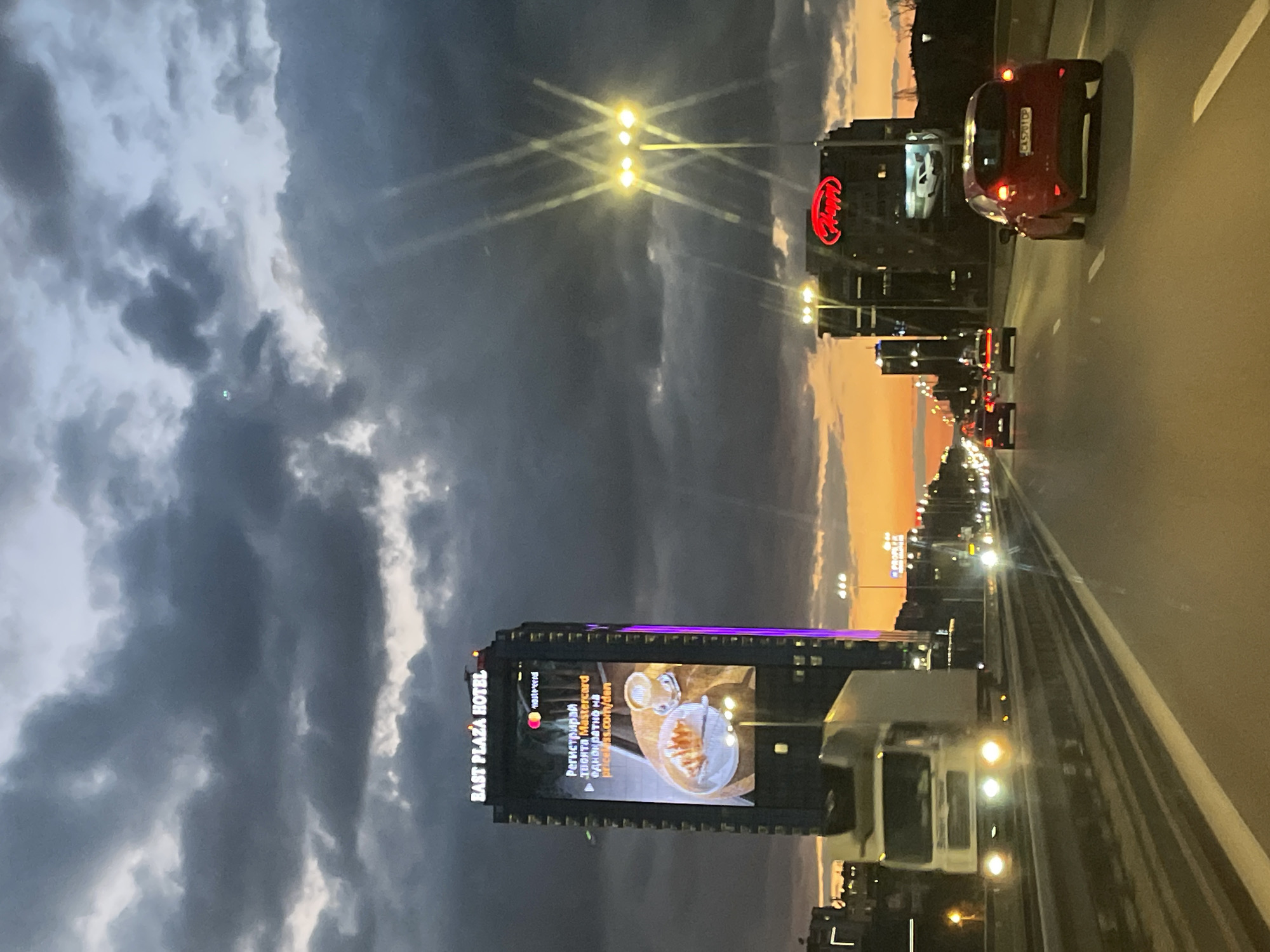 Highway approach to Sofia captured at dusk with dramatic clouds