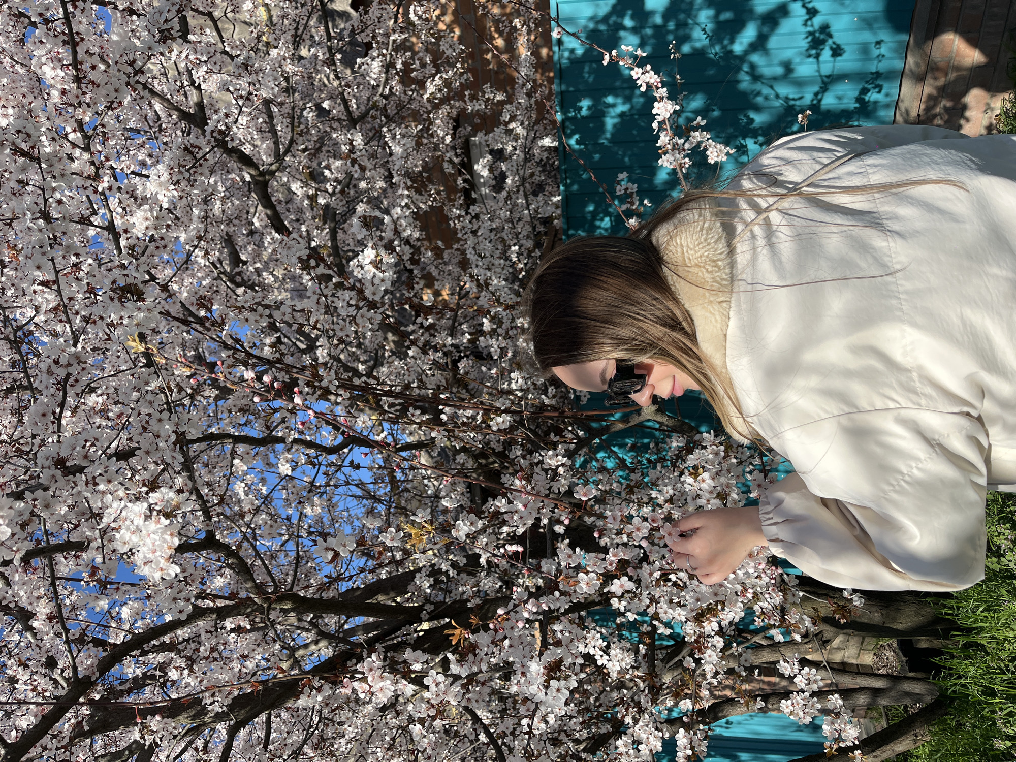 Woman poses with spring blossoms in Russian village photo session