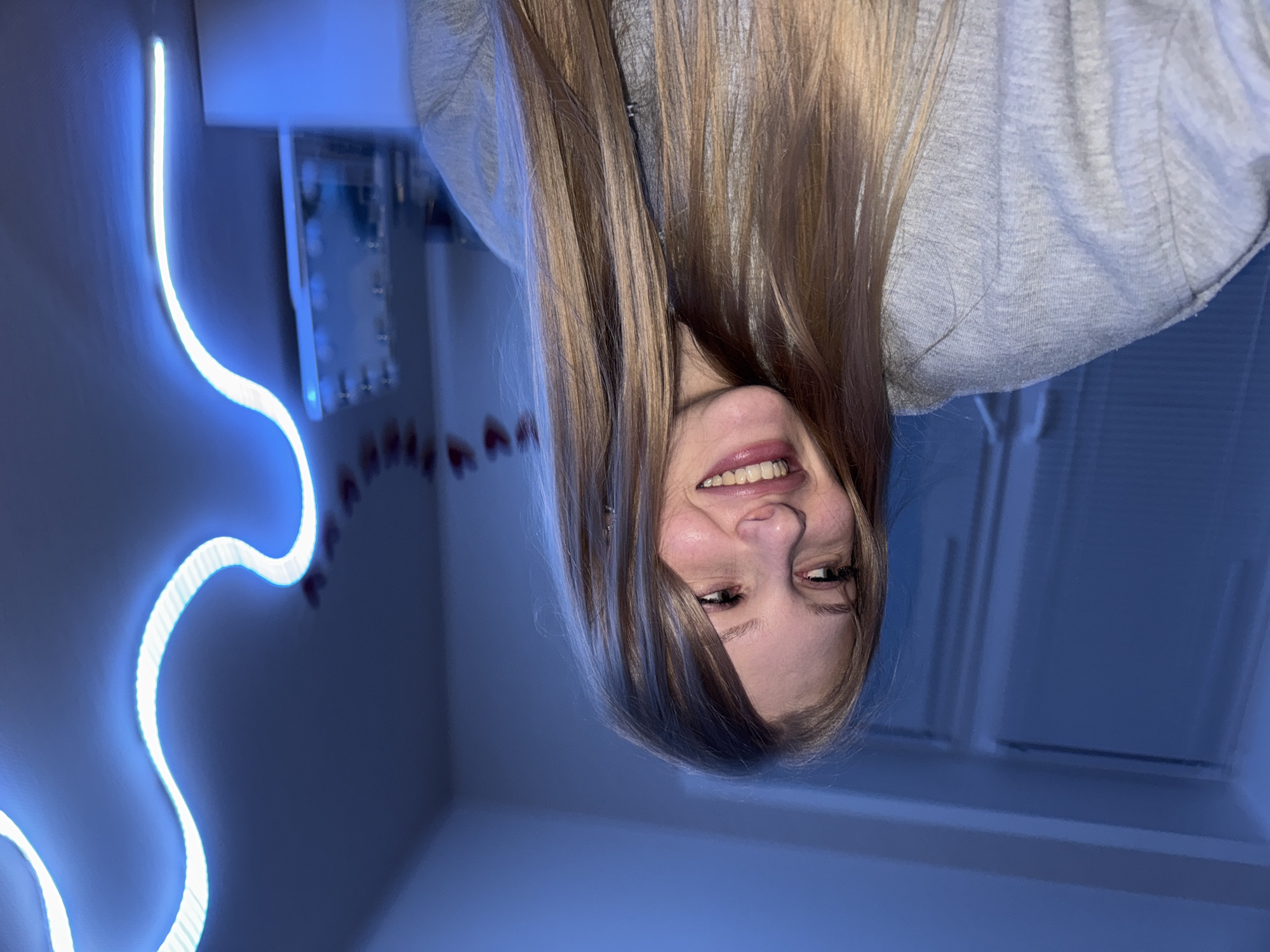 Portrait session in a neon-lit room in Perm