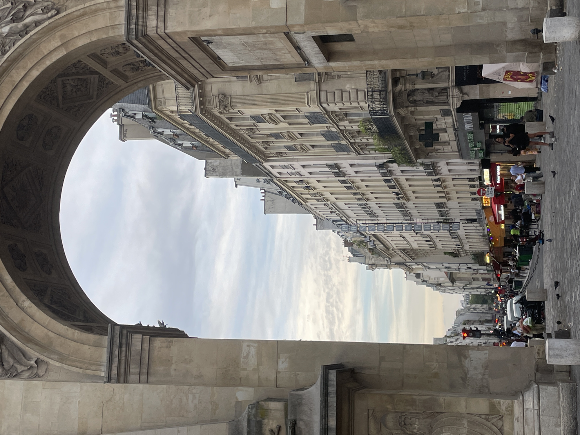 Evening street scenes documented at Paris's Porte Saint-Denis arch