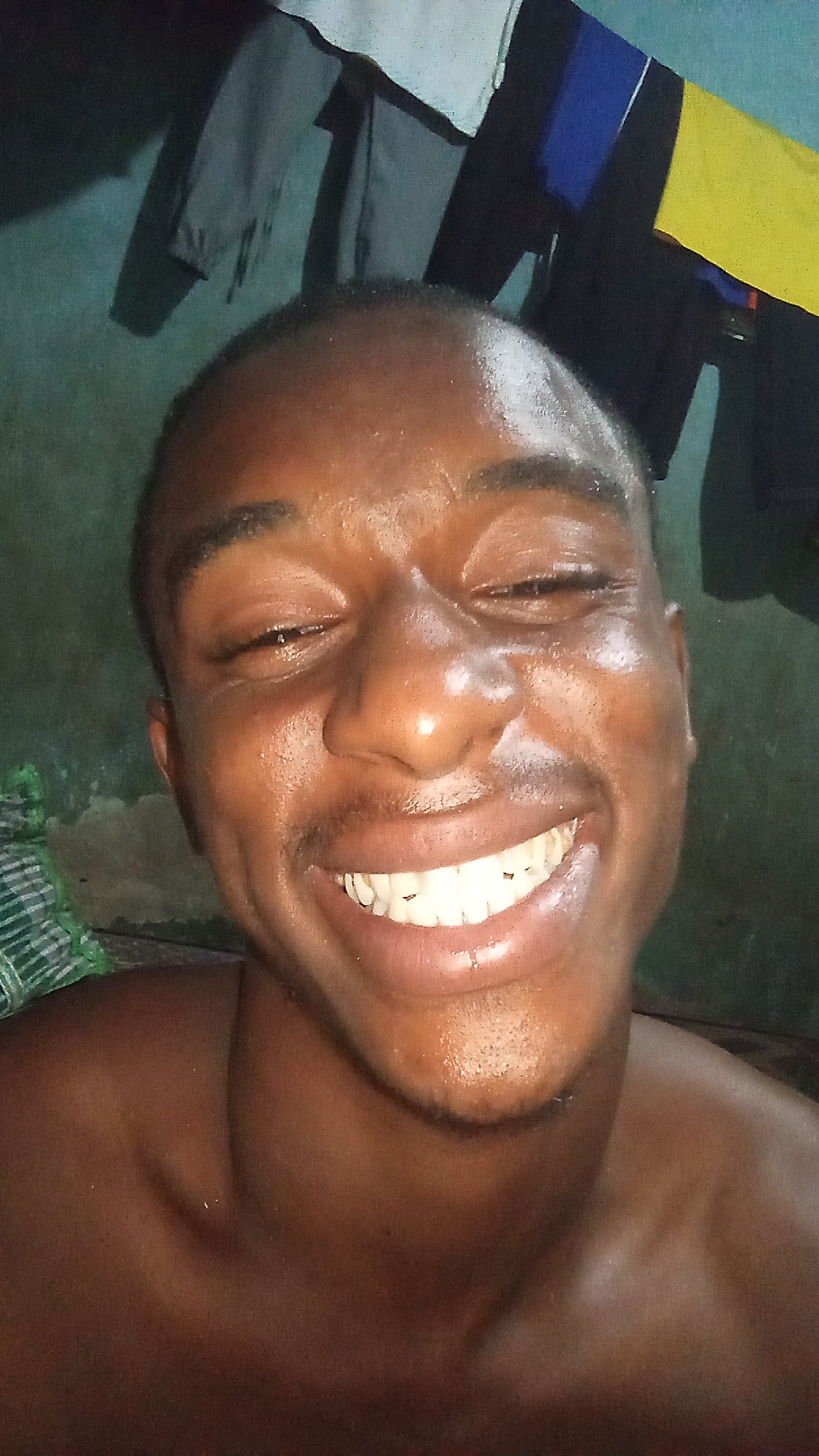 Young man enjoys Coca-Cola at home in Onitsha