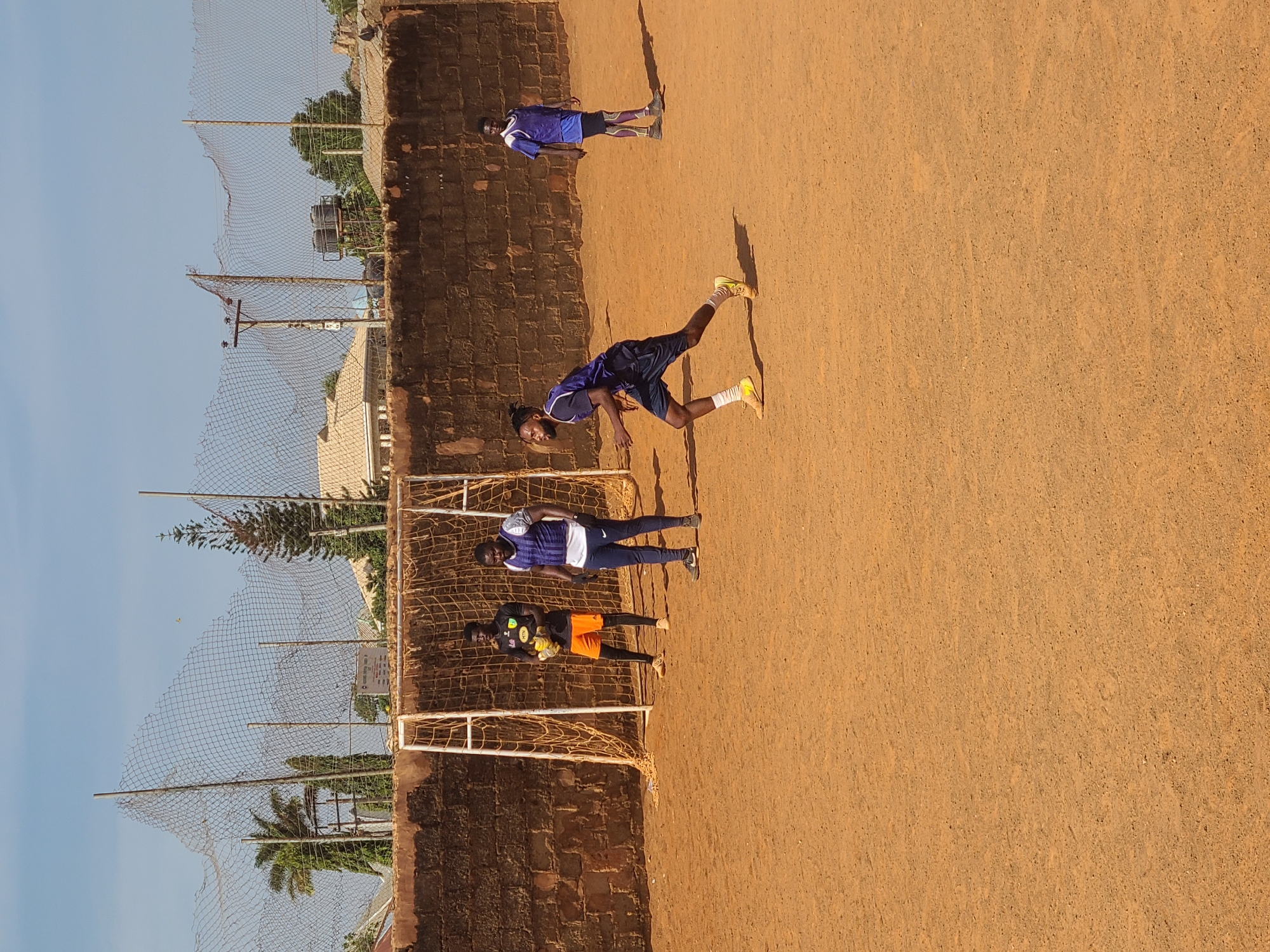 Morning soccer match on dirt field in Nigerian village