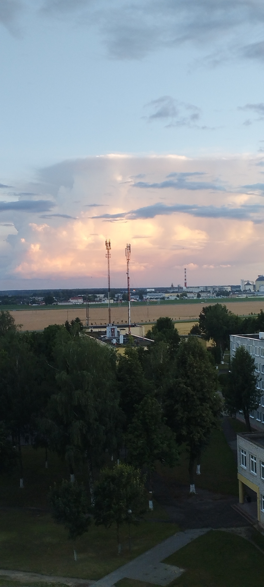 Dramatic sunset sky over Skidzieĺ apartment blocks, July 2026