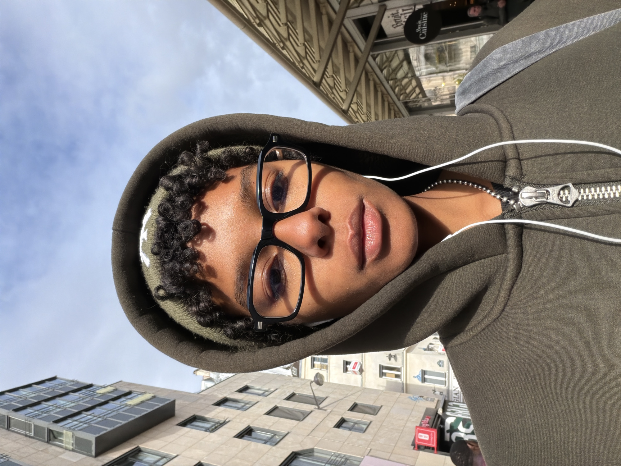 Person takes selfie among modern buildings in Paris