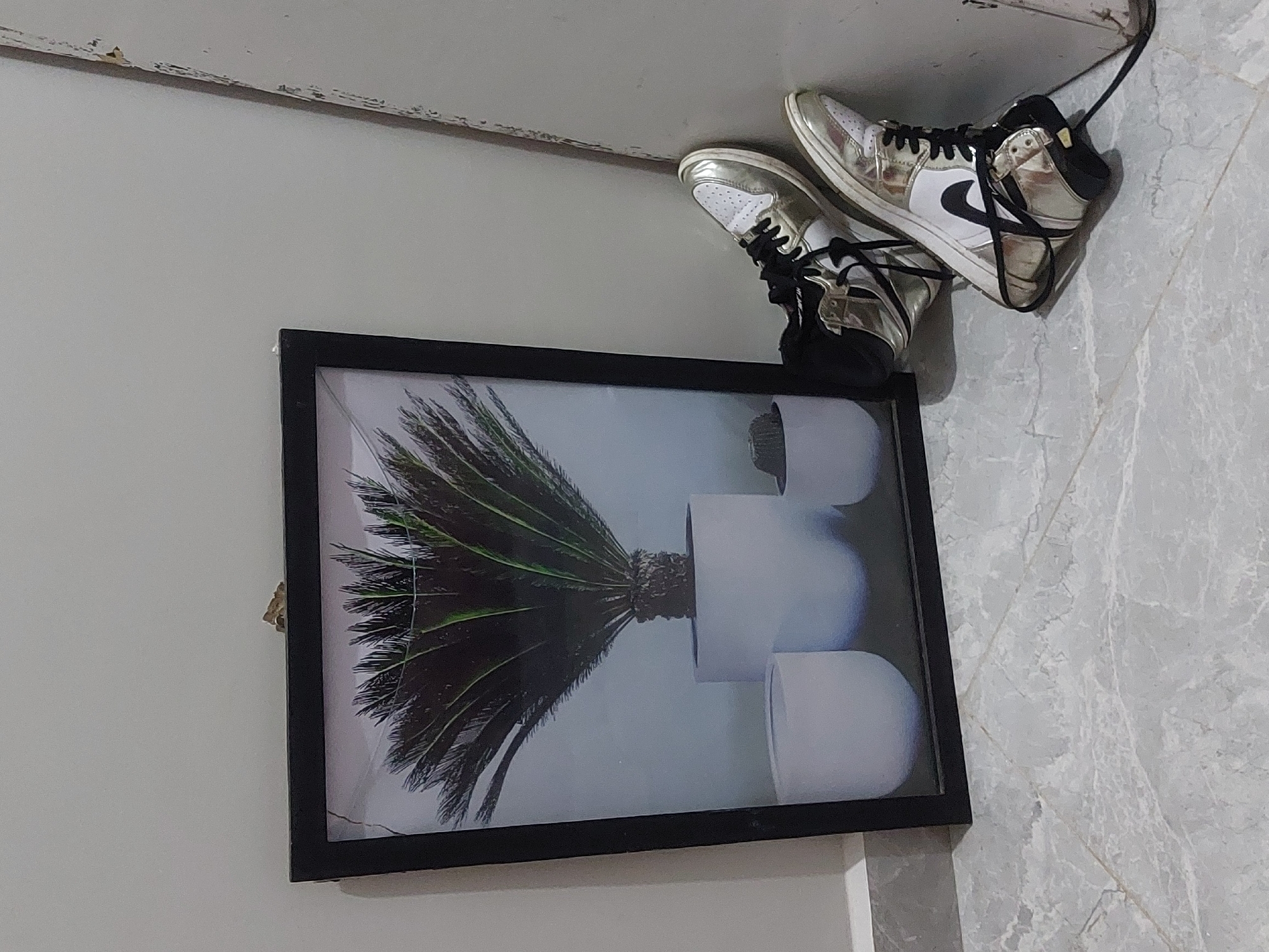 Dar es-Salaam resident documents sneakers, crystals in indoor setting