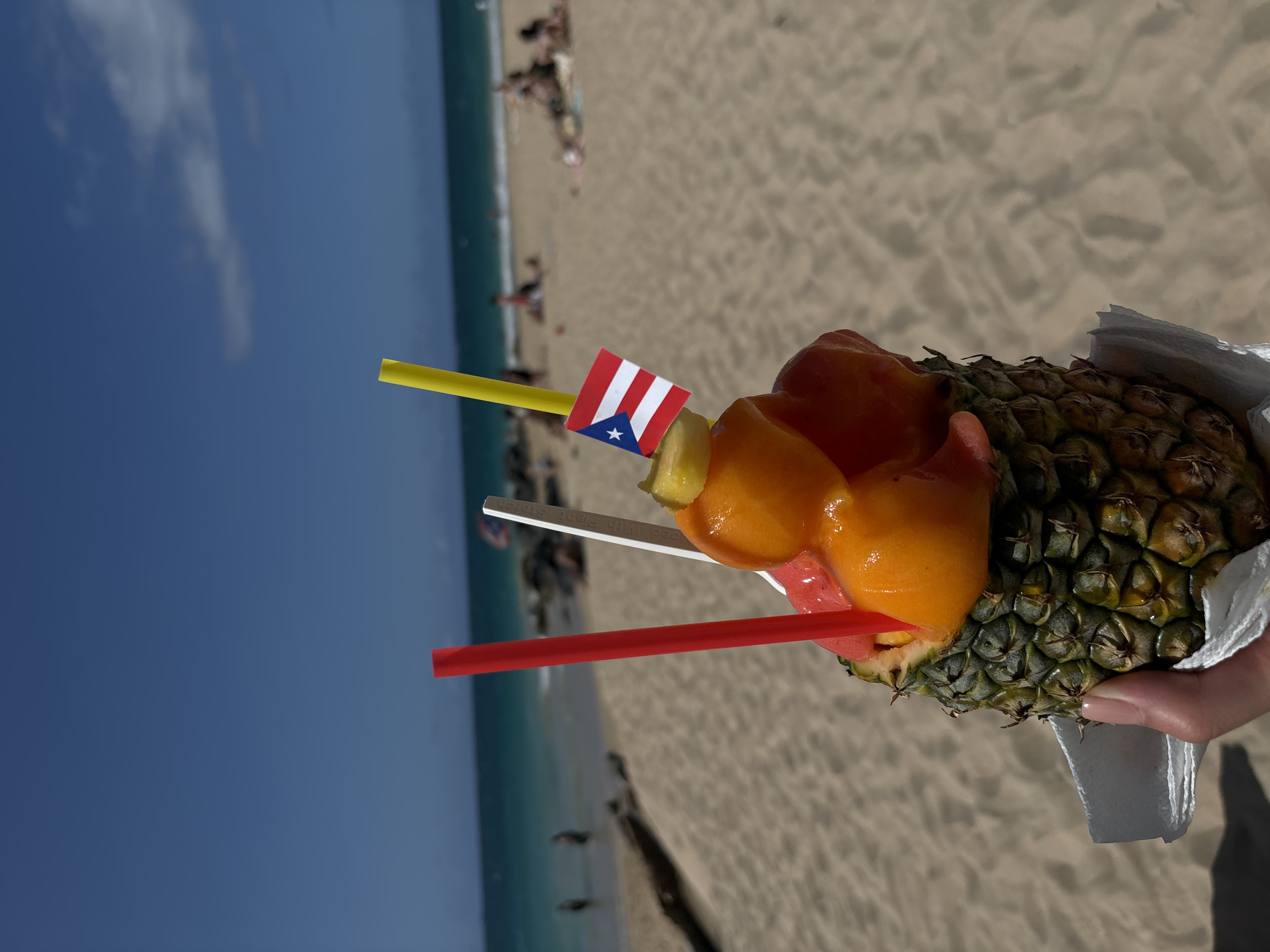 Pineapple fruit cups served fresh at a San Juan beach stand