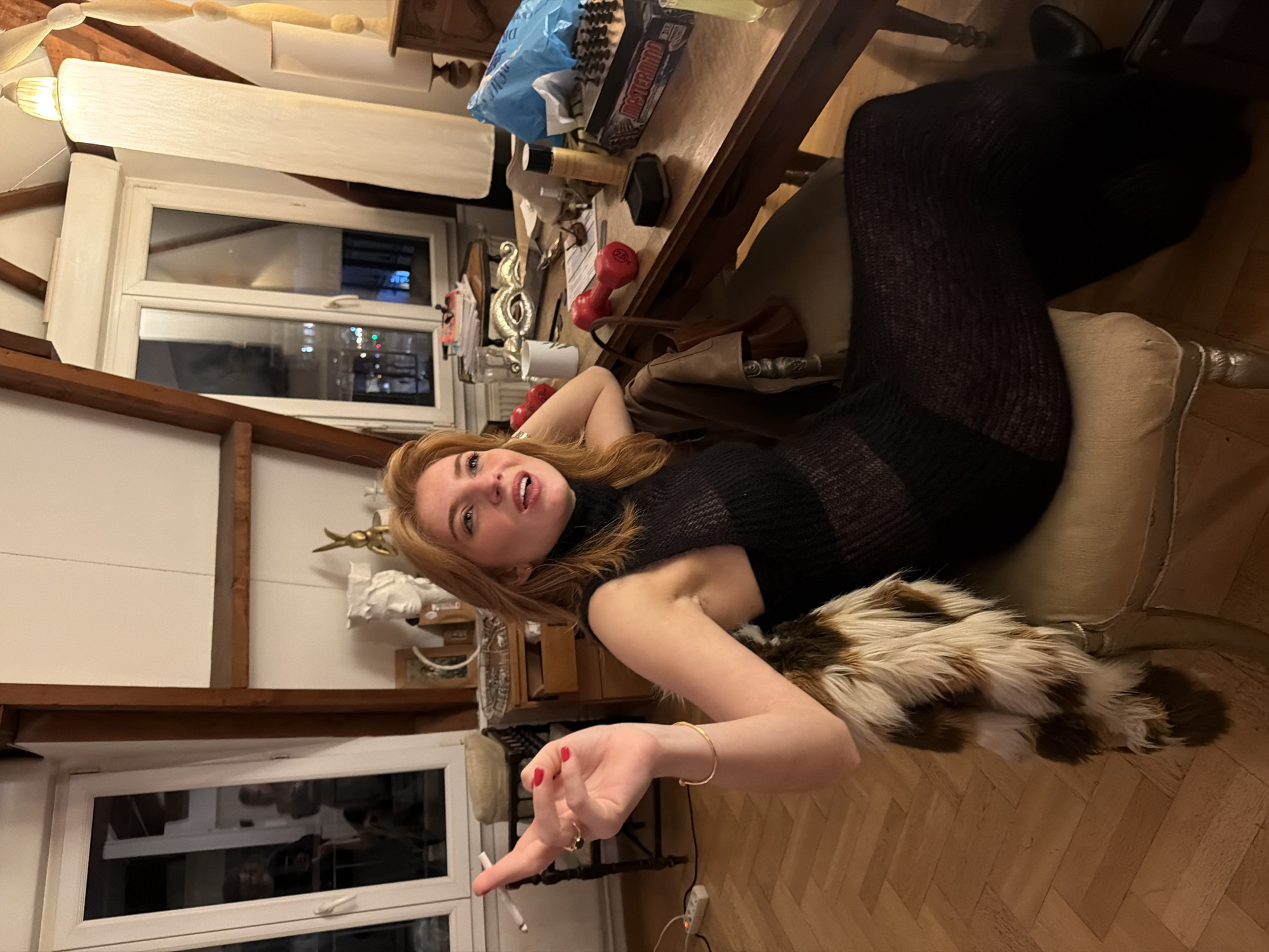 Woman in eclectic Paris room captured in evening scene