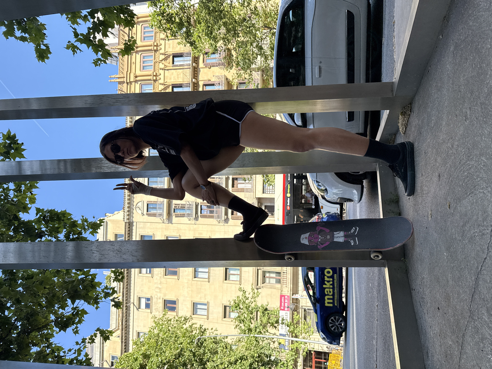 Woman skateboards on metal monument structure in Barcelona