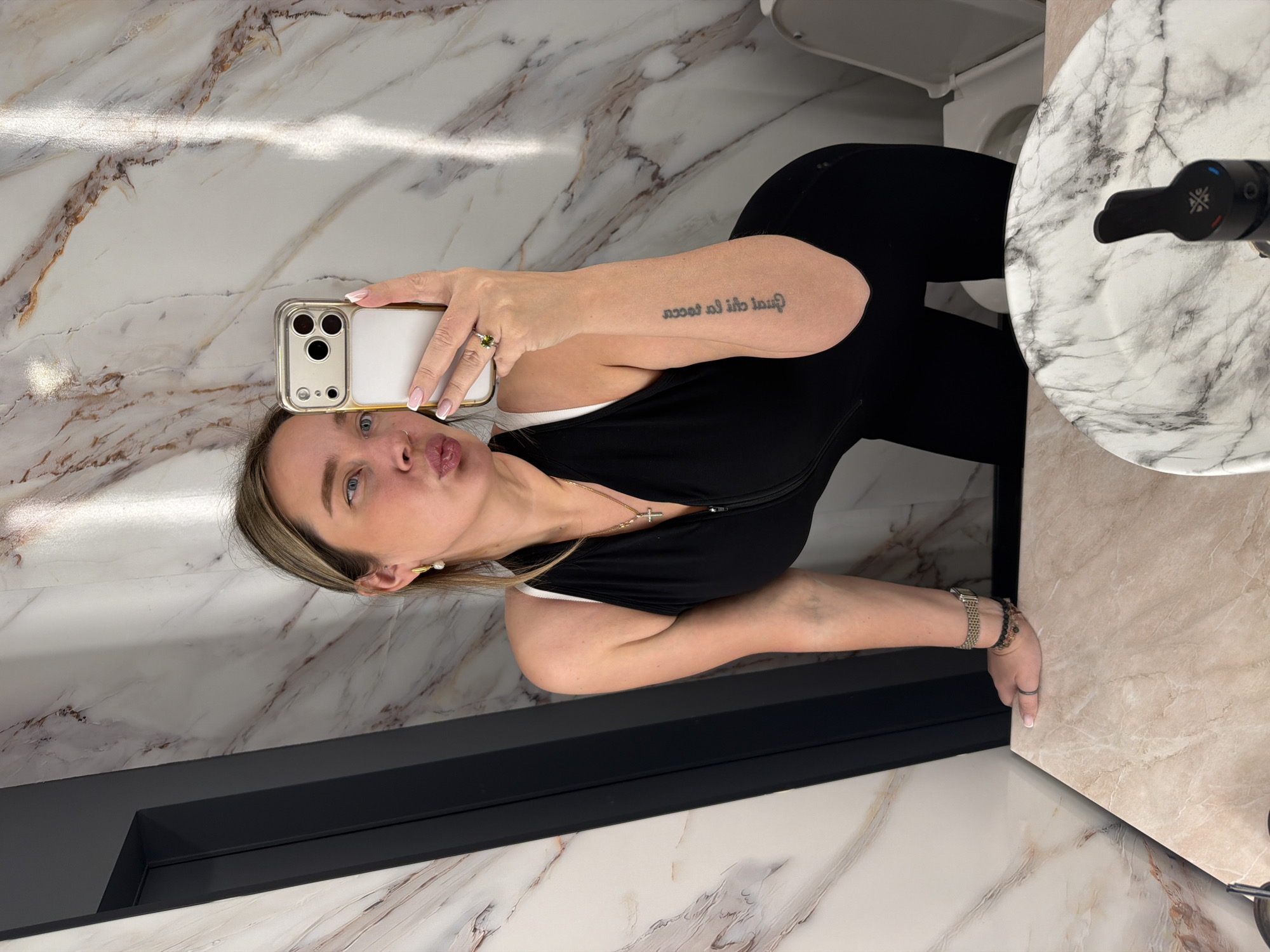 Woman photographed in Moscow bathroom wearing white lace, jewelry