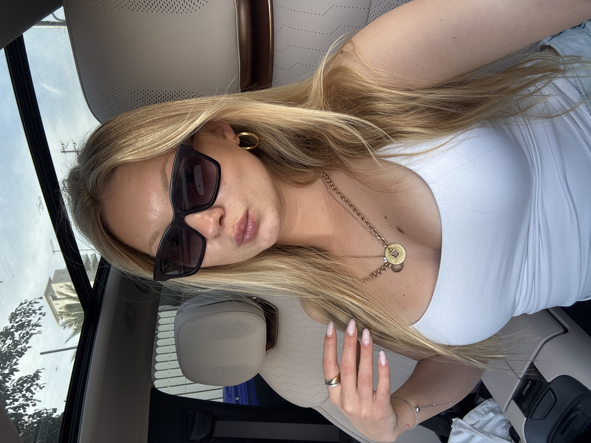 Woman takes car selfie in sunny Netanya