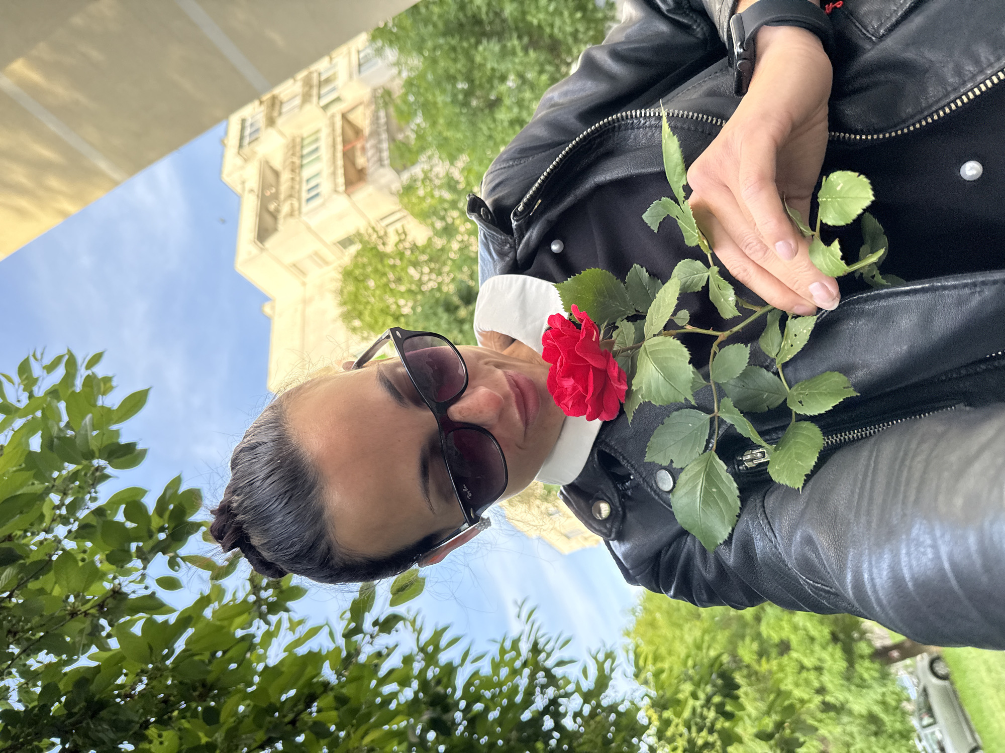 Woman films selfie with red rose in Pleven