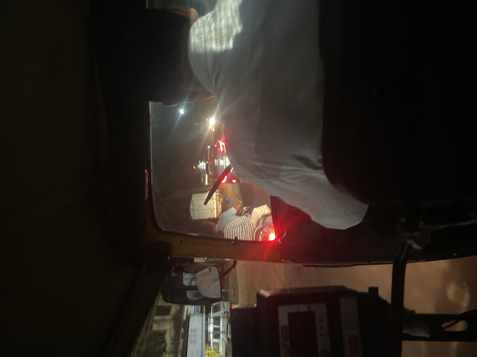 Nighttime auto-rickshaw ride captured in Kudal, India