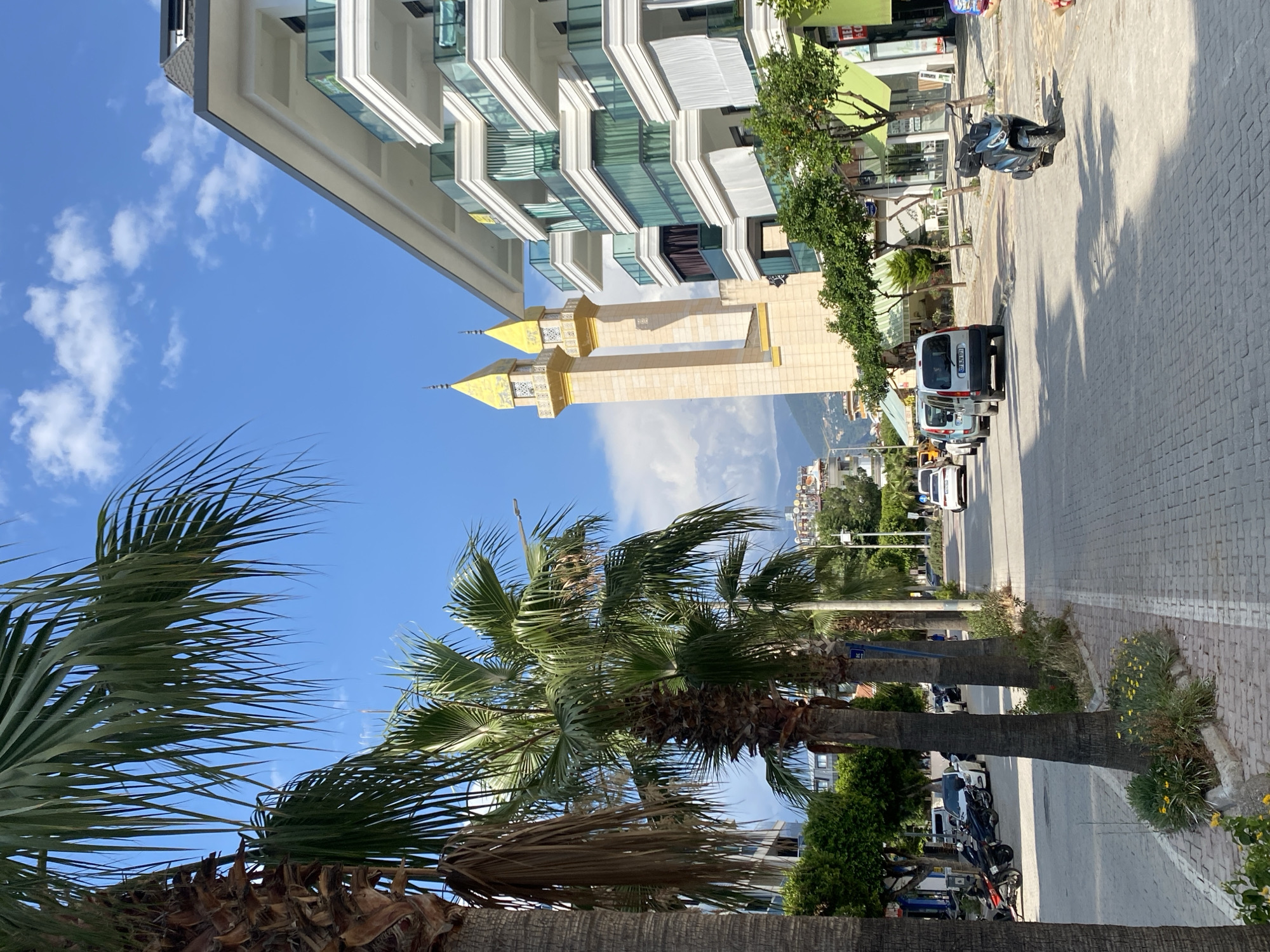 Alanya's beachfront streets, mosque, and shoreline at midday