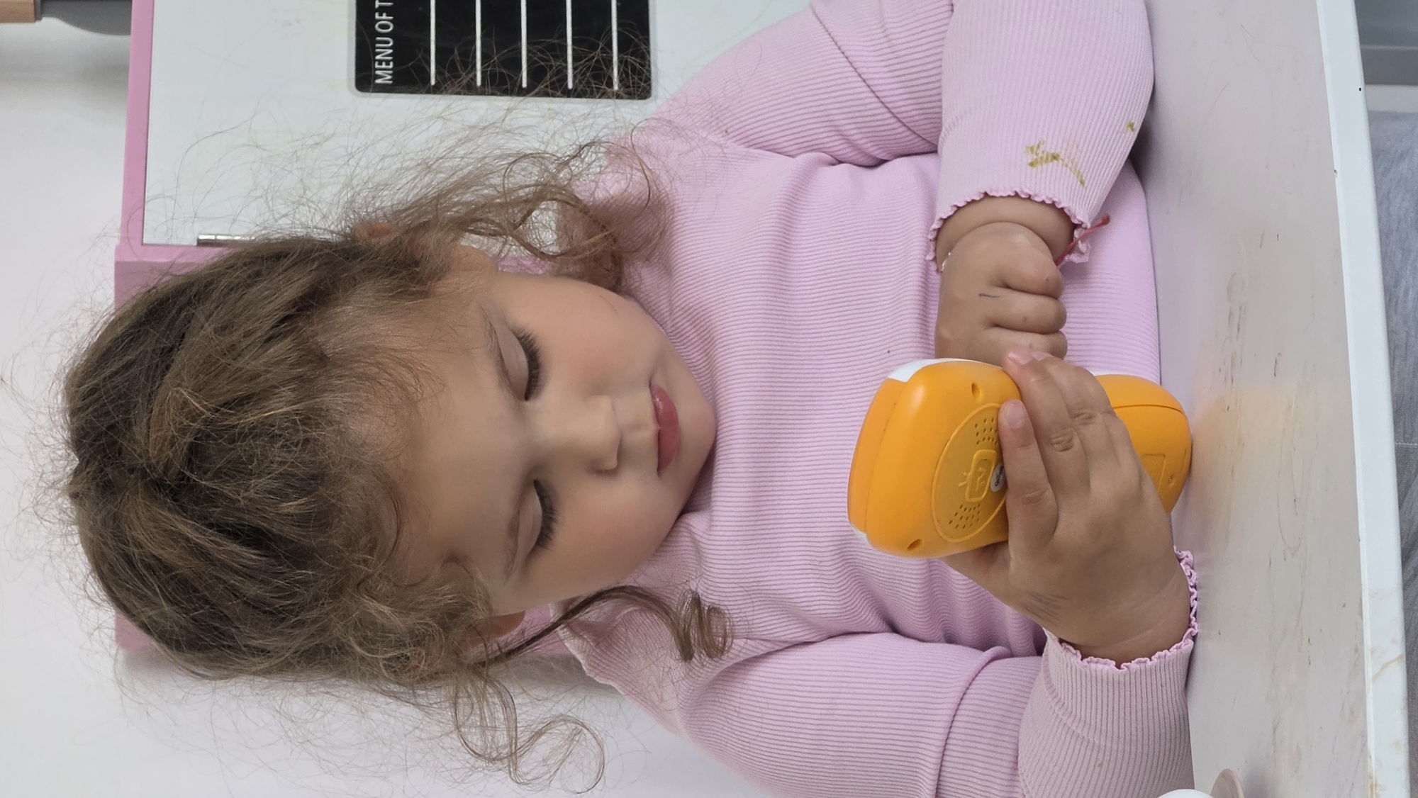 Child rests peacefully on white surface in London