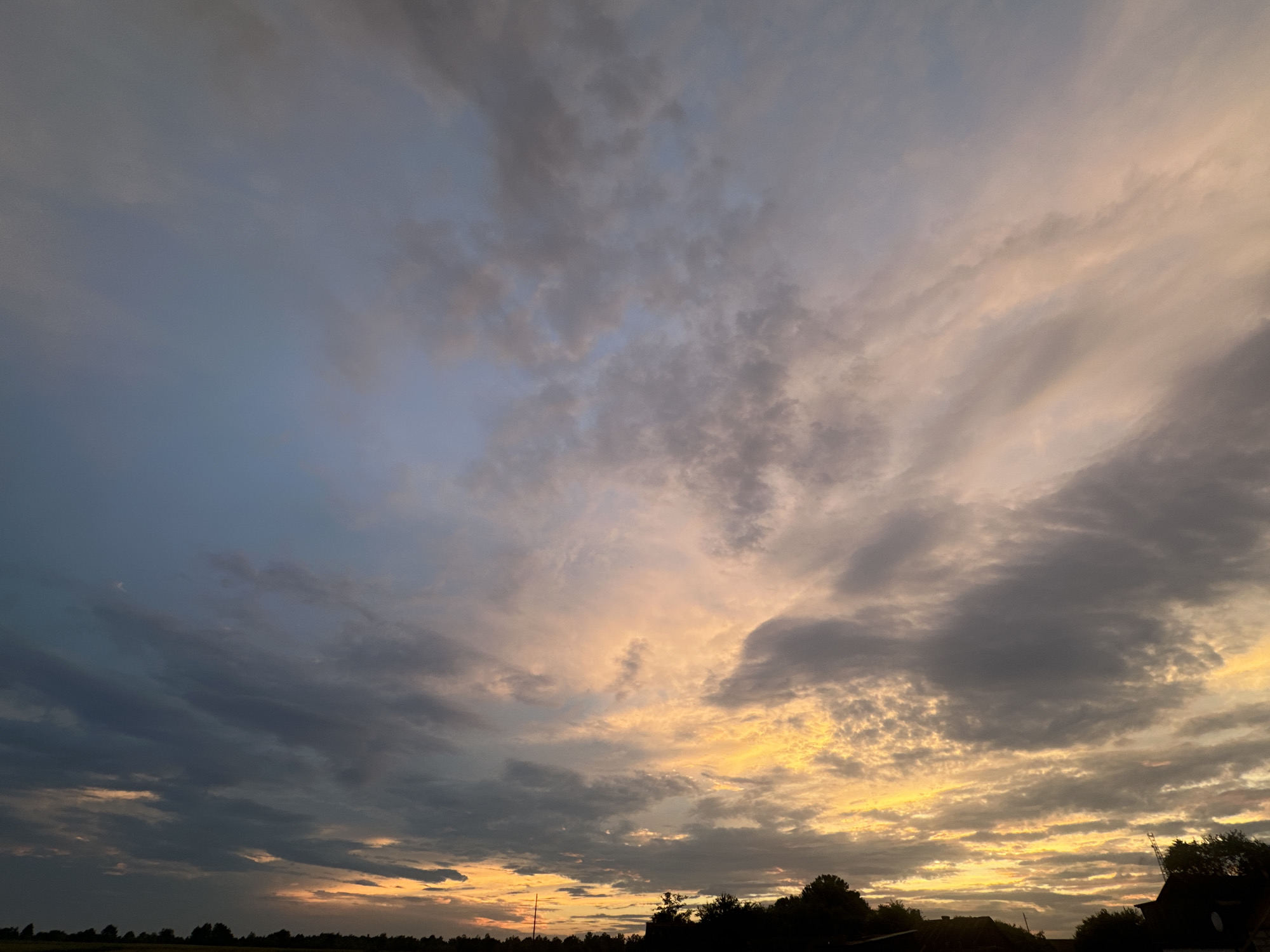 Layered clouds and shifting color during a brief sunset window