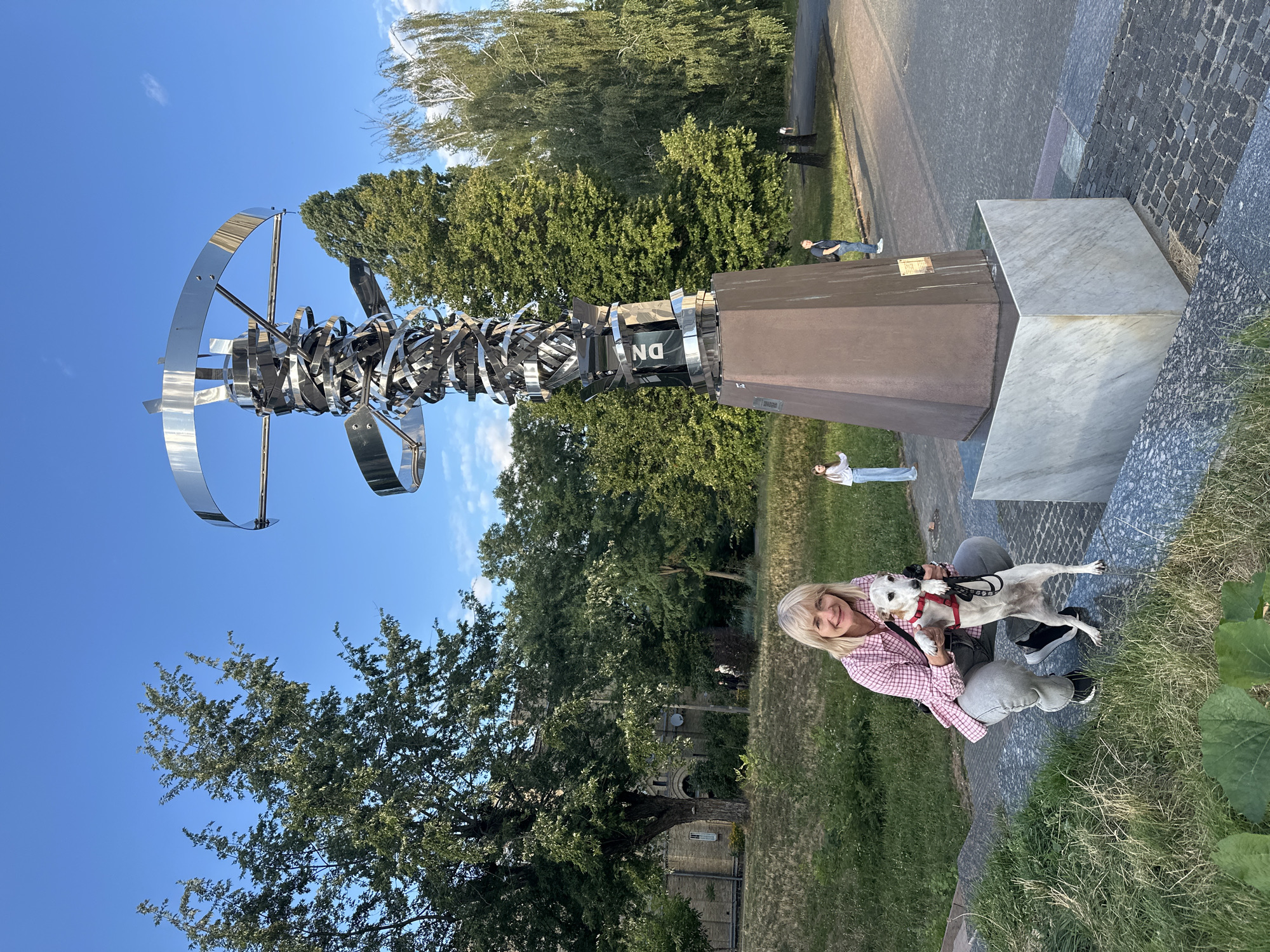 Afternoon stroll around a Kyiv square with dogs, sculptures, and street details