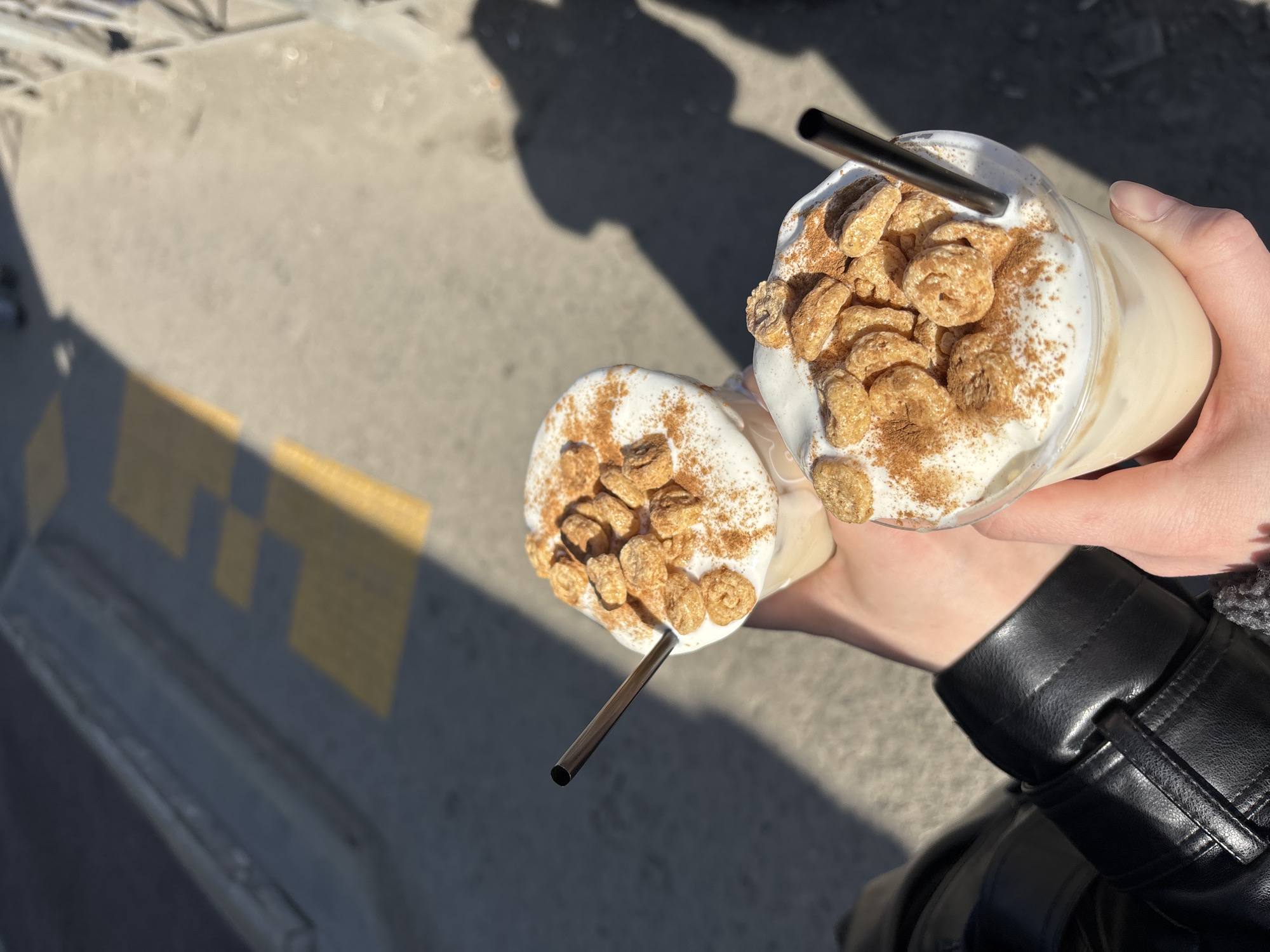 Two people share cold drinks on sunny Perm street