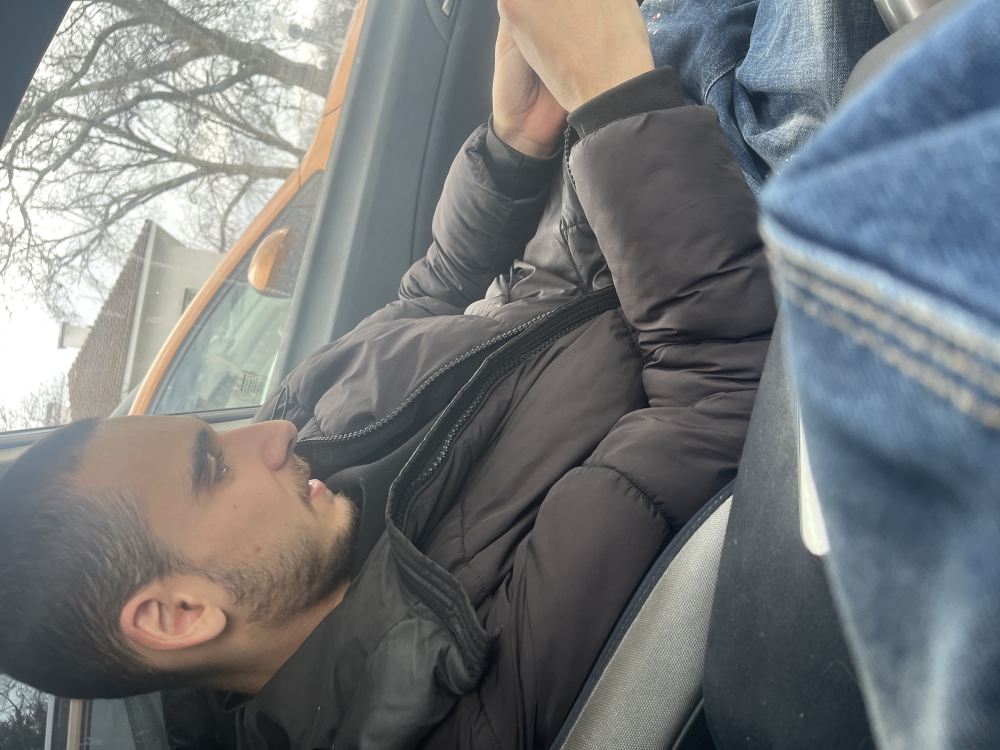 Man using phone in car during early morning in Varna