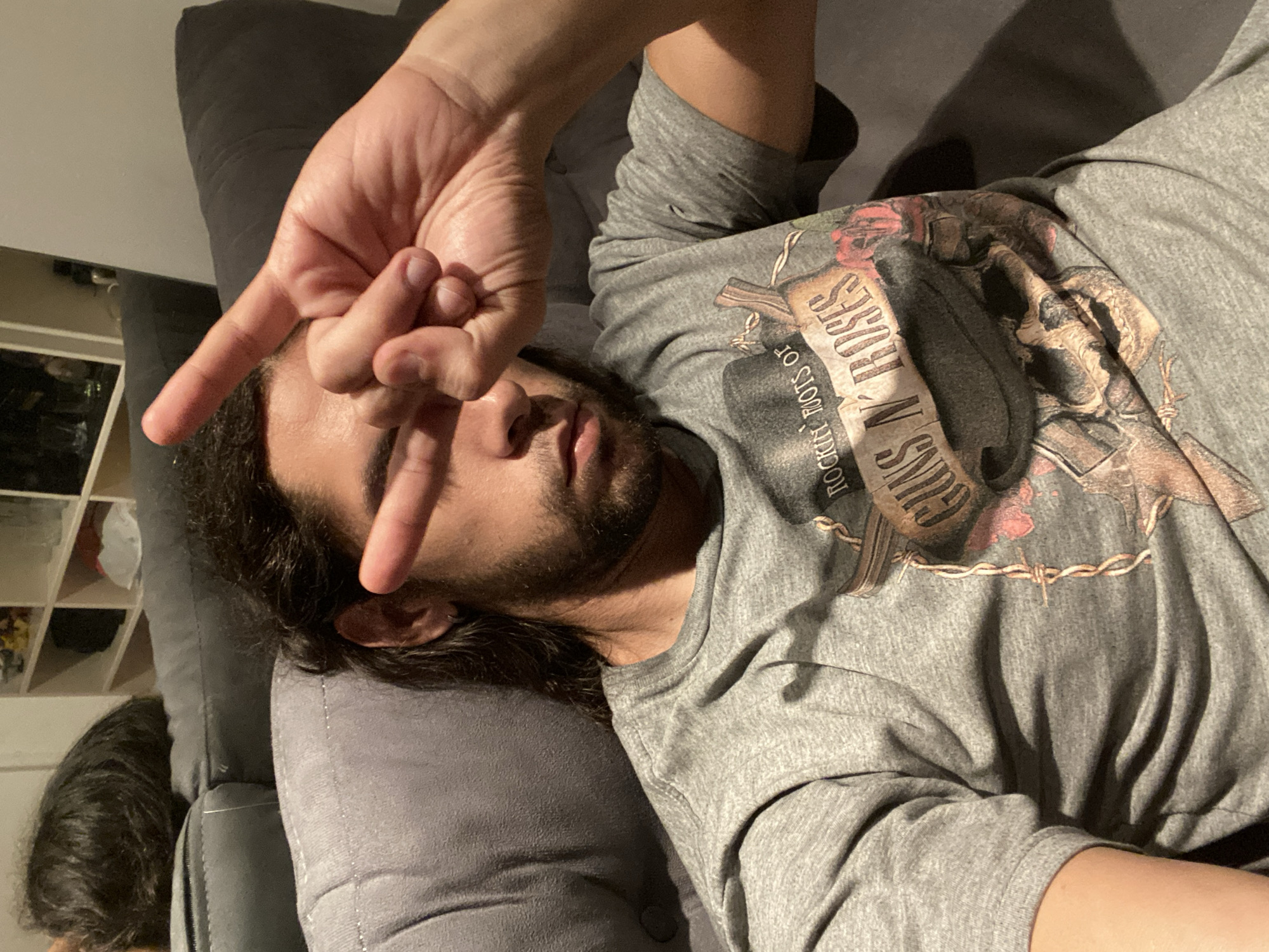 Person makes peace sign while relaxing on couch in Buenos Aires