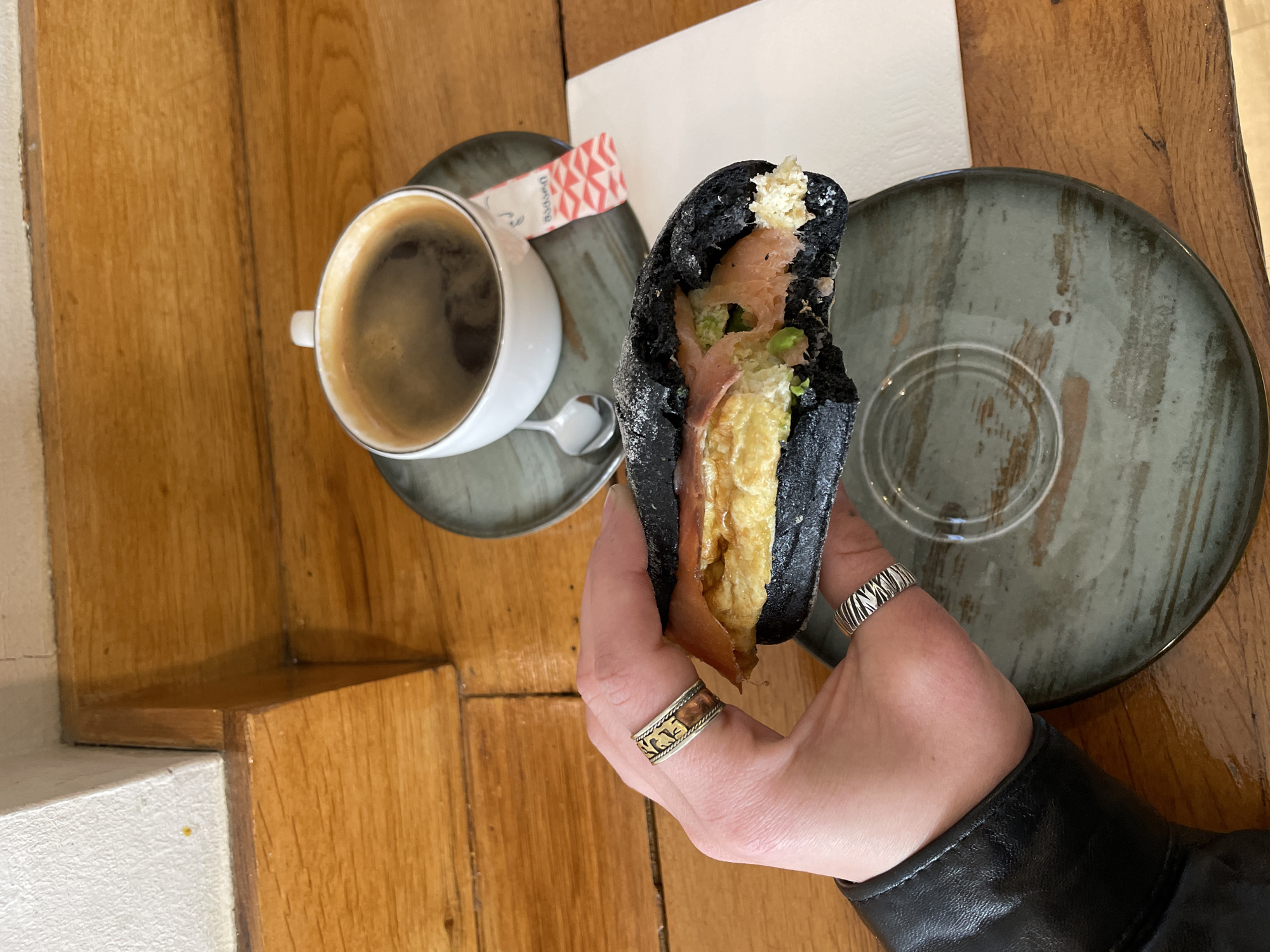 Morning cafe dining captured in Tbilisi featuring charcoal sandwich