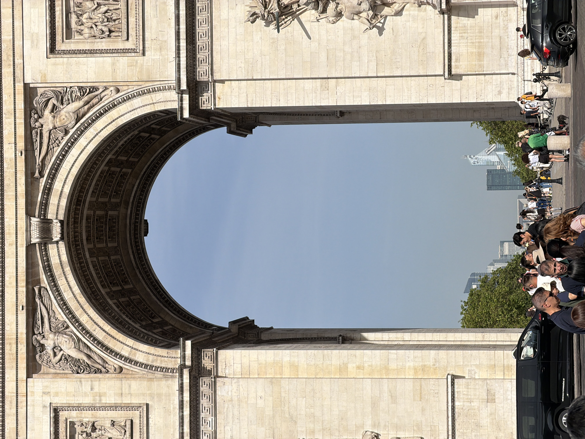 Street musician performs saxophone near Arc de Triomphe