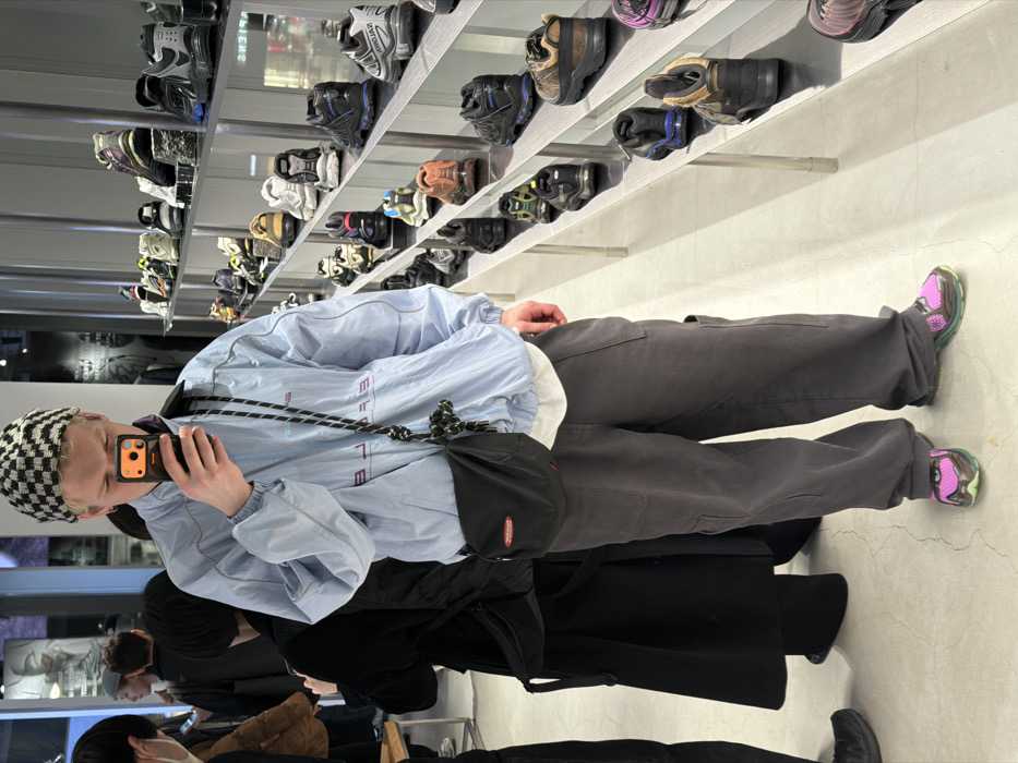 Person takes mirror selfie in Shibuya retail store