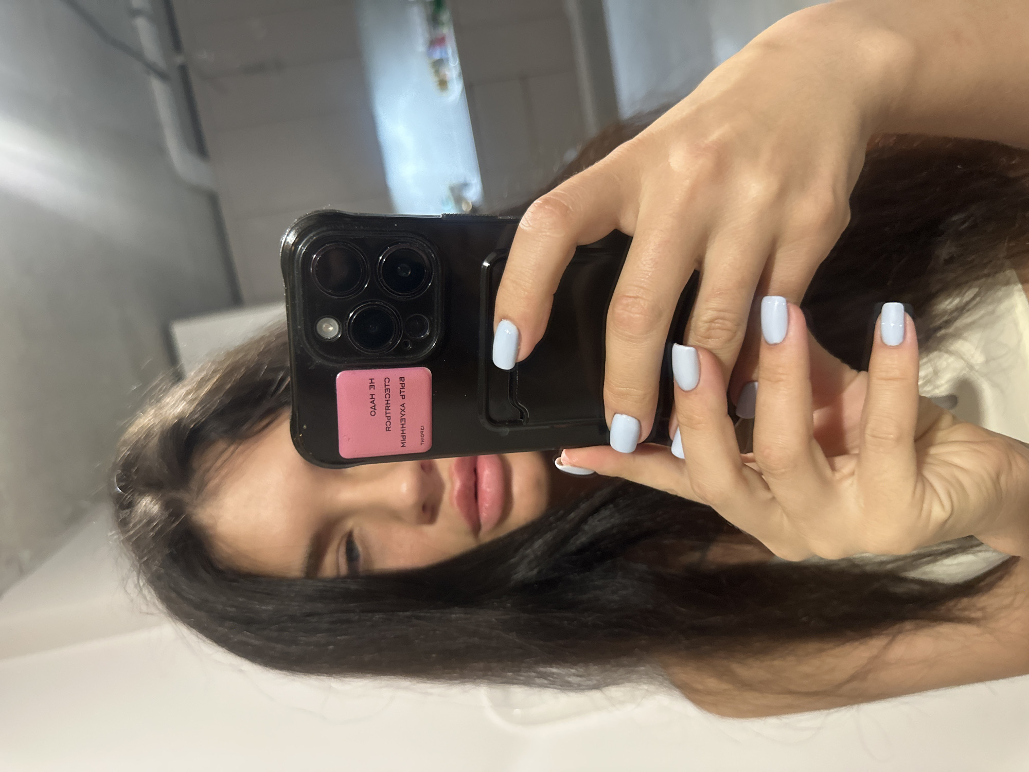 Woman takes bathroom mirror selfies in Khimki, Russia
