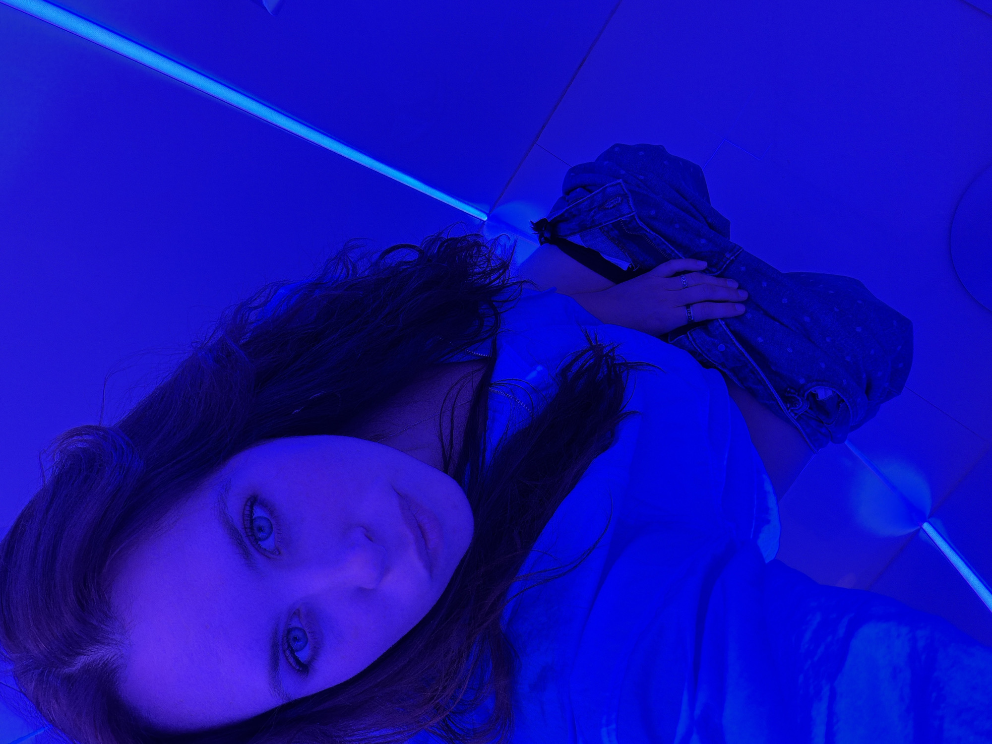 Woman takes blue-lit restroom selfies in Moscow establishment