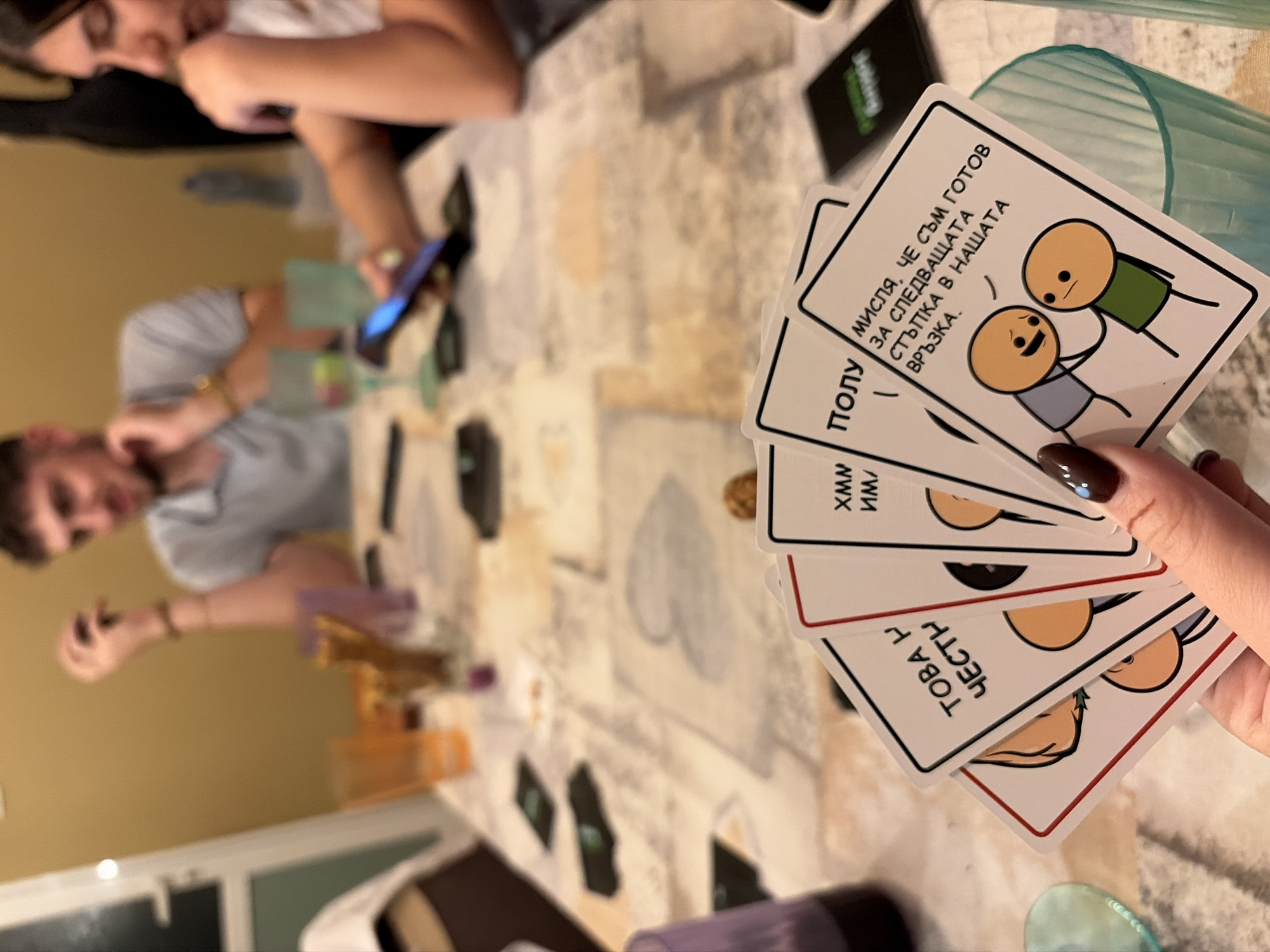 Friends play Joking Hazard card game in Plovdiv home