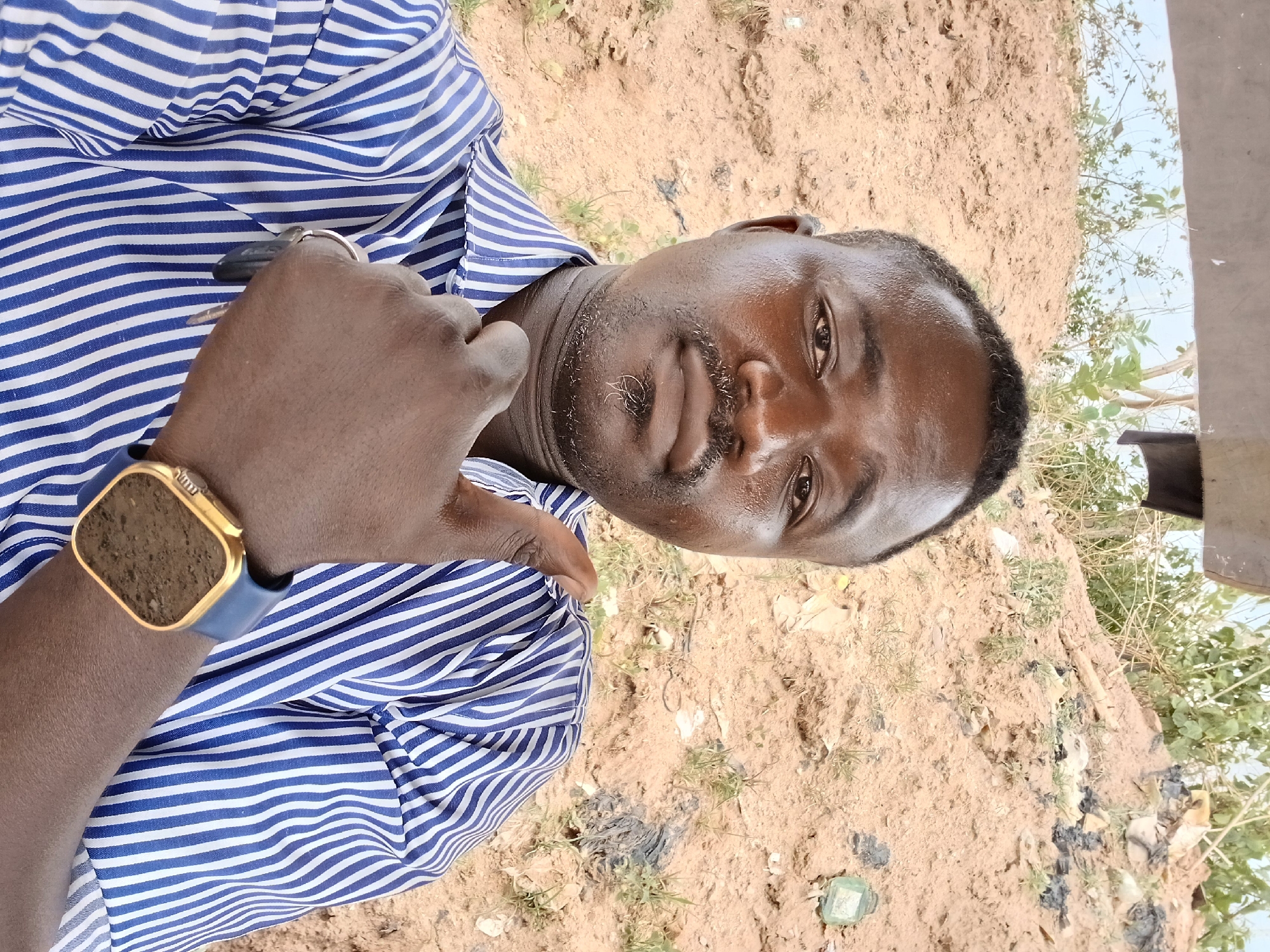 Man in striped shirt observed standing in Abuja