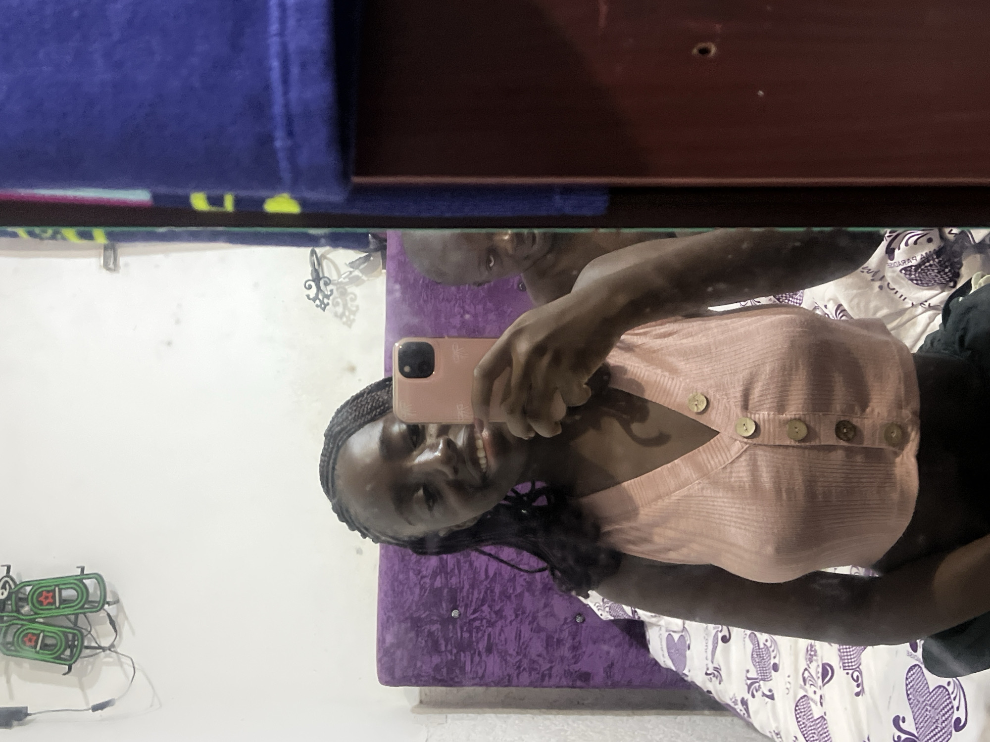 Woman takes morning selfie in Abuja bedroom