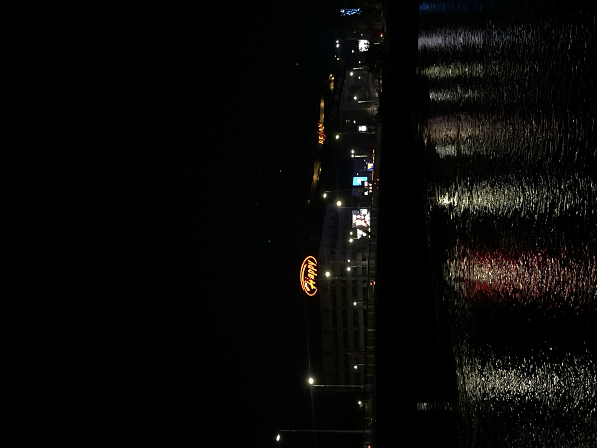 Plovdiv restaurant lights reflect in water at nighttime