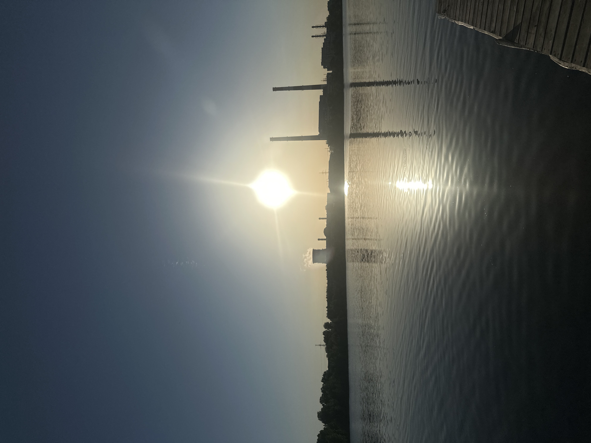 Man contemplates waterfront near industrial area in Kazan