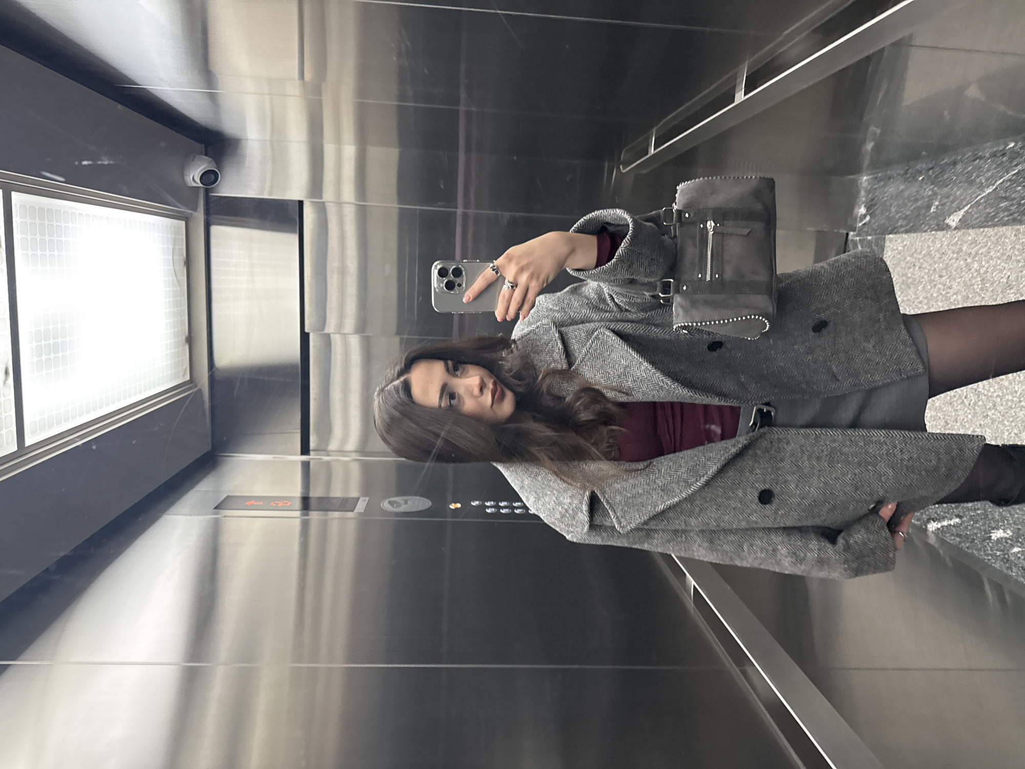 Woman takes elevator selfie, kitchen view captured in Yerevan