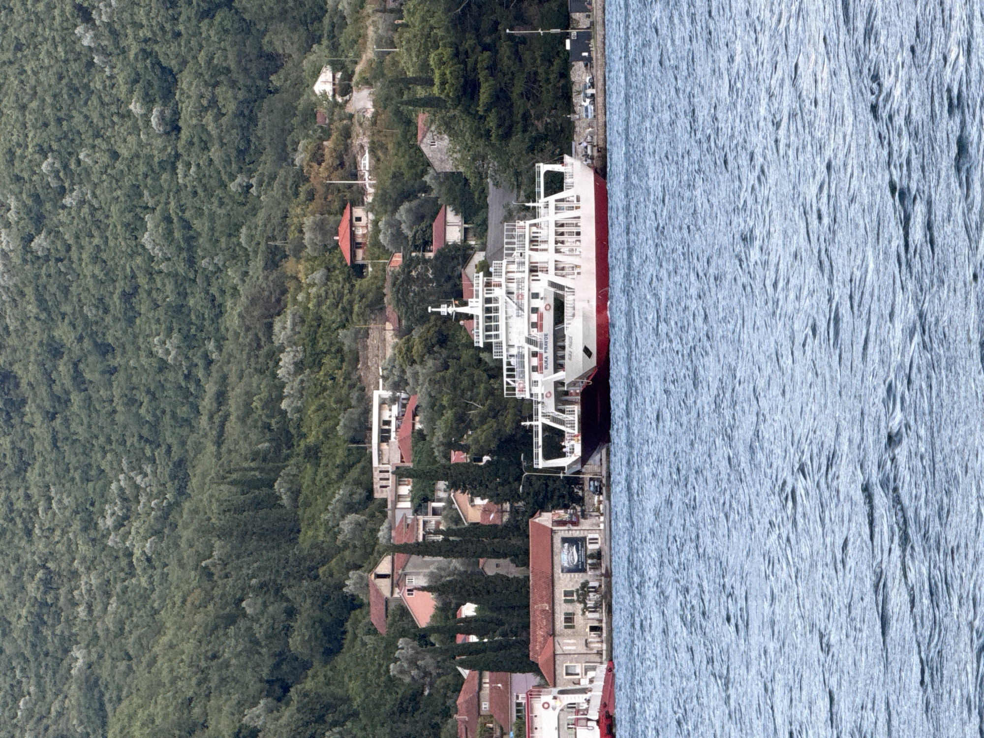 Ferry, sailboats, and summer activity on the Bay of Kotor