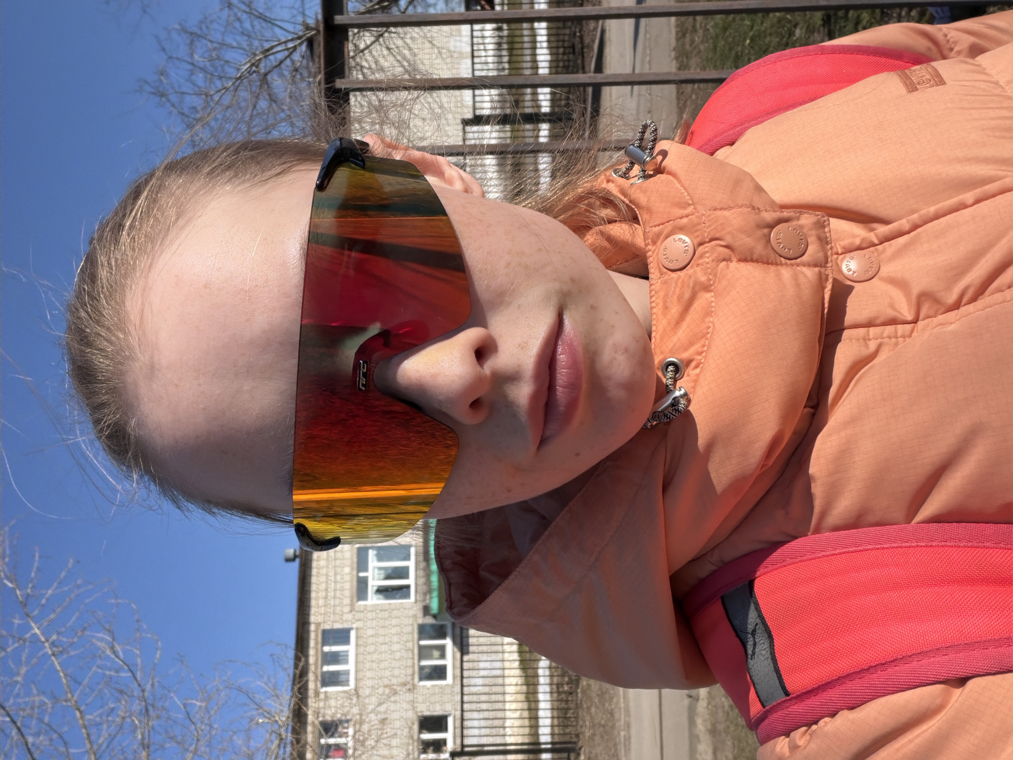 Person in orange goggles, peach jacket photographed in Berezniki
