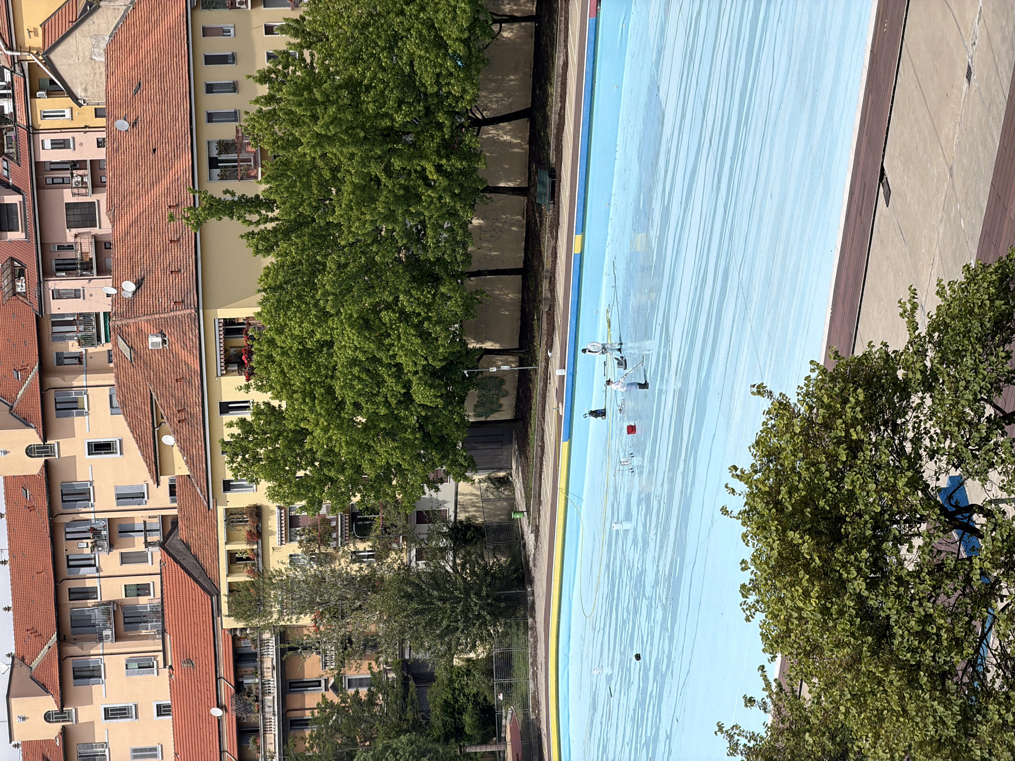 Pool maintenance workers clean swimming facility in Milan