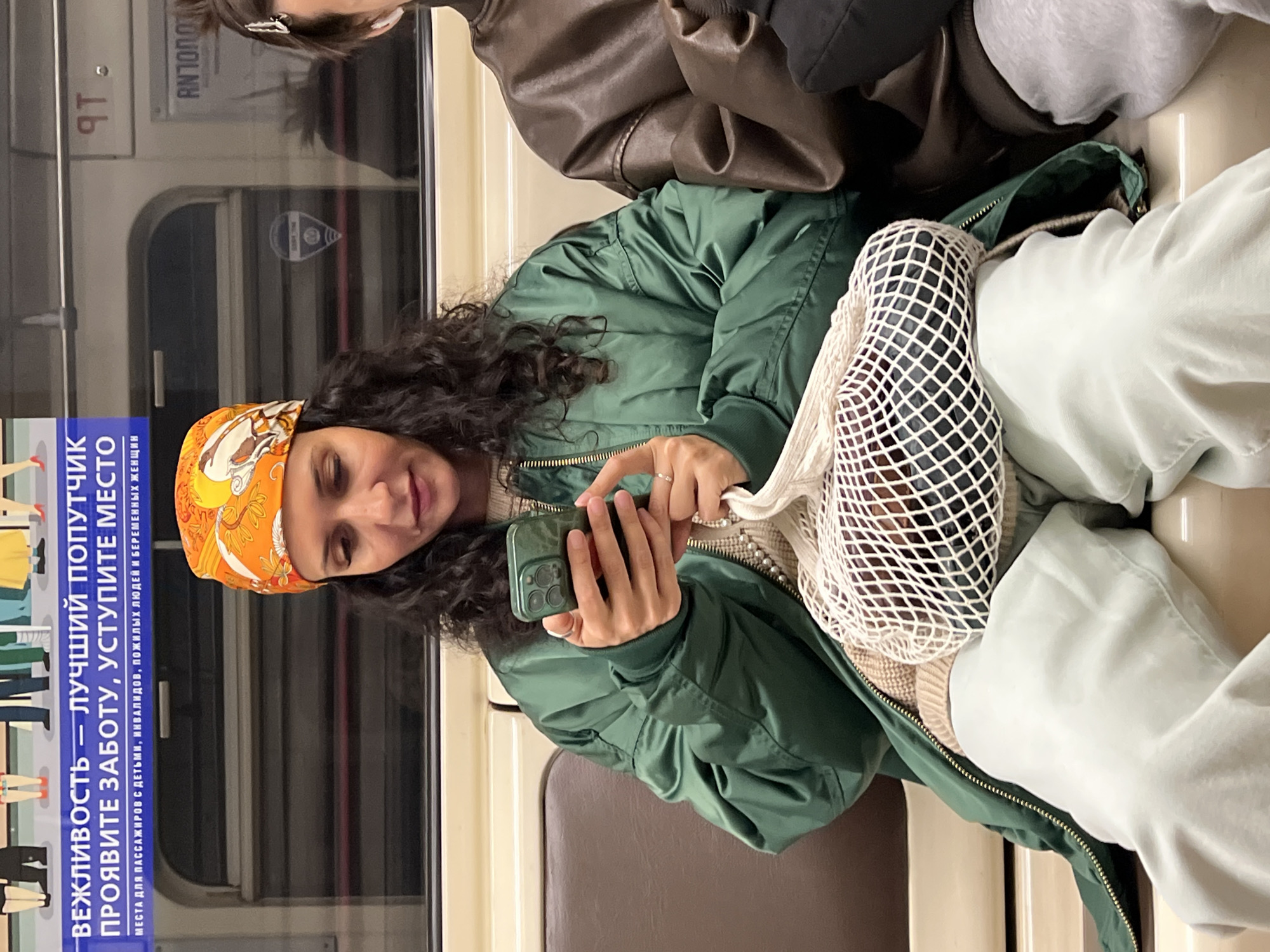Woman uses smartphone on train in Shushary, Russia