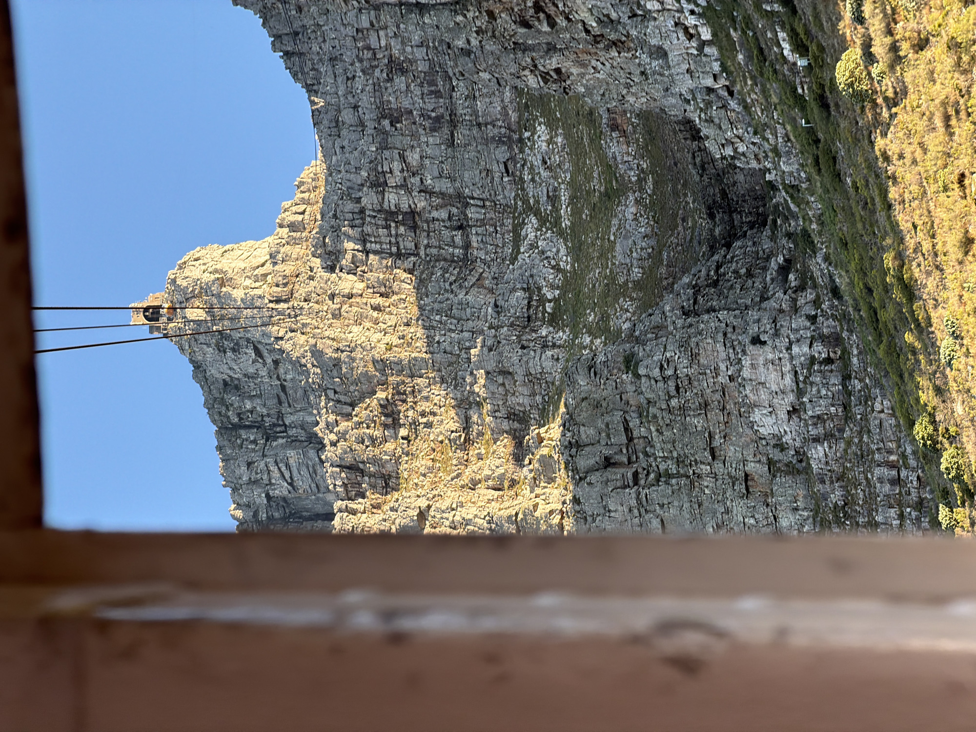Sideways cliff photo captured under clear skies in Cape Town