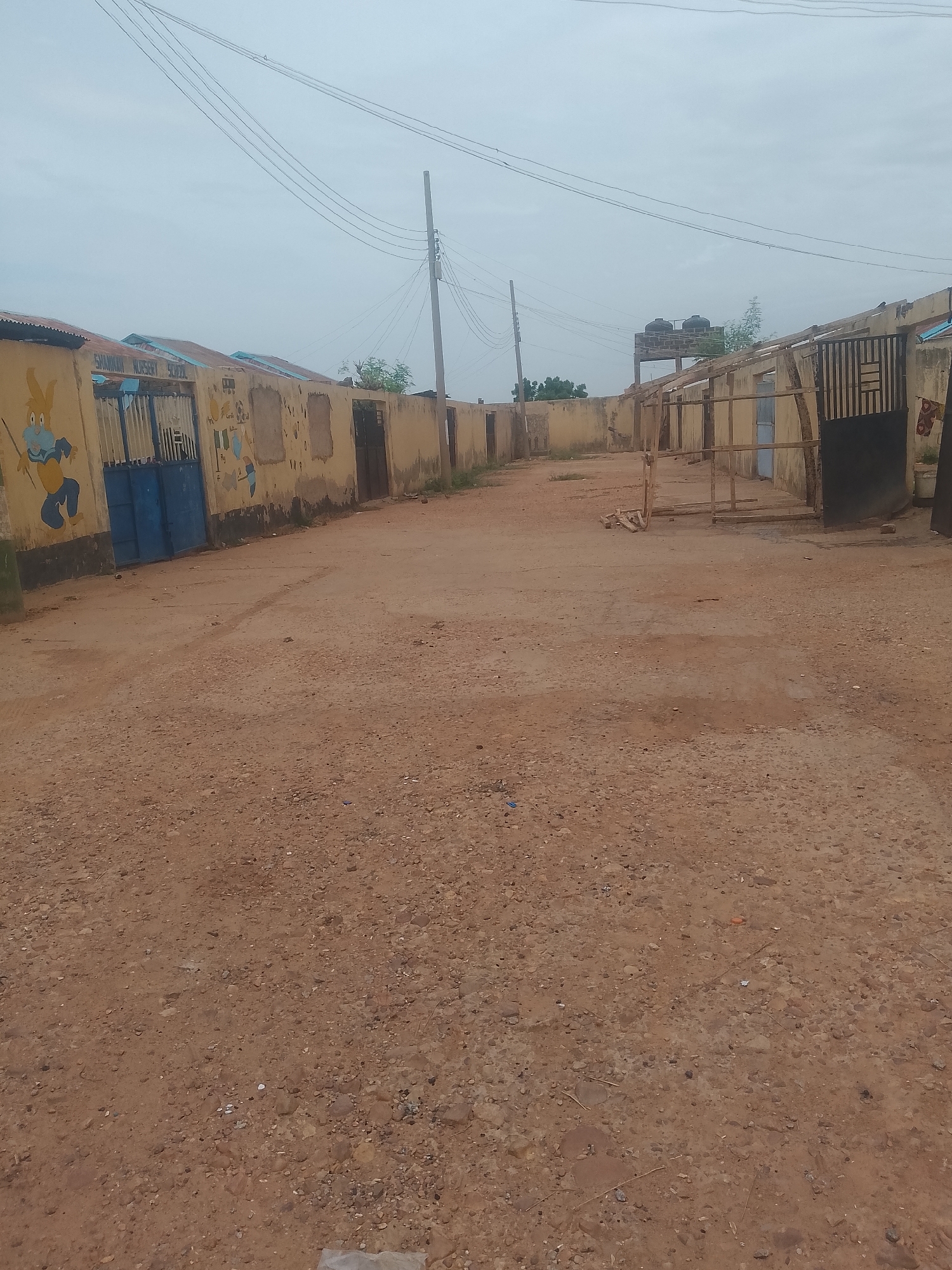 Street scenes through a quiet Nigerian neighborhood, walls and roads