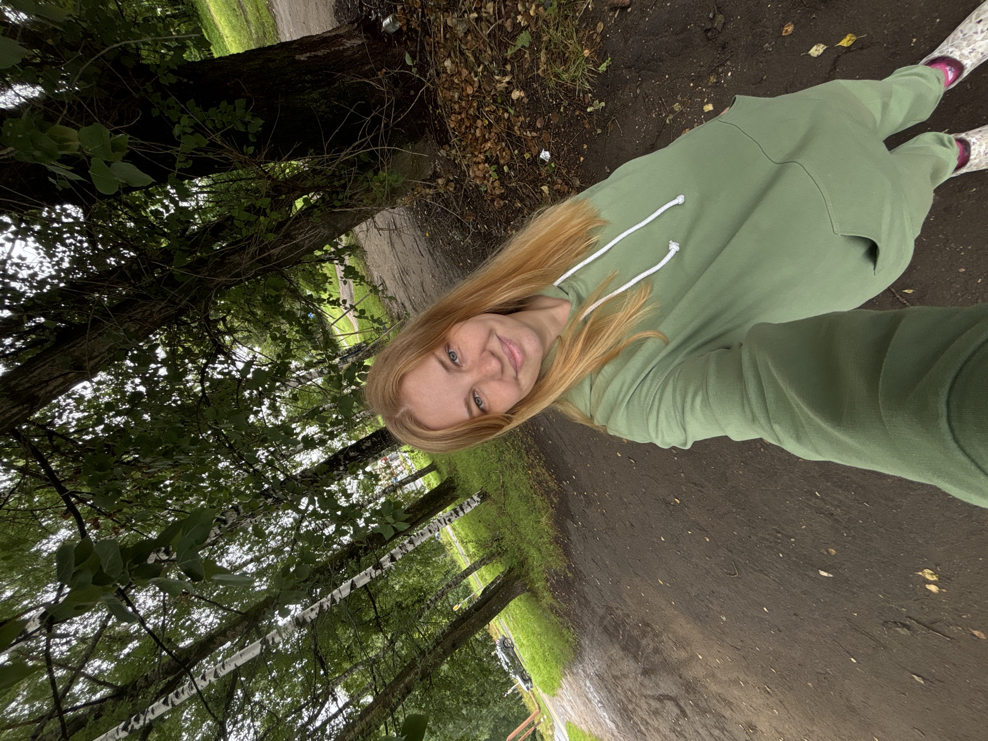 Casual moments along a tree-lined park path in Breytovo