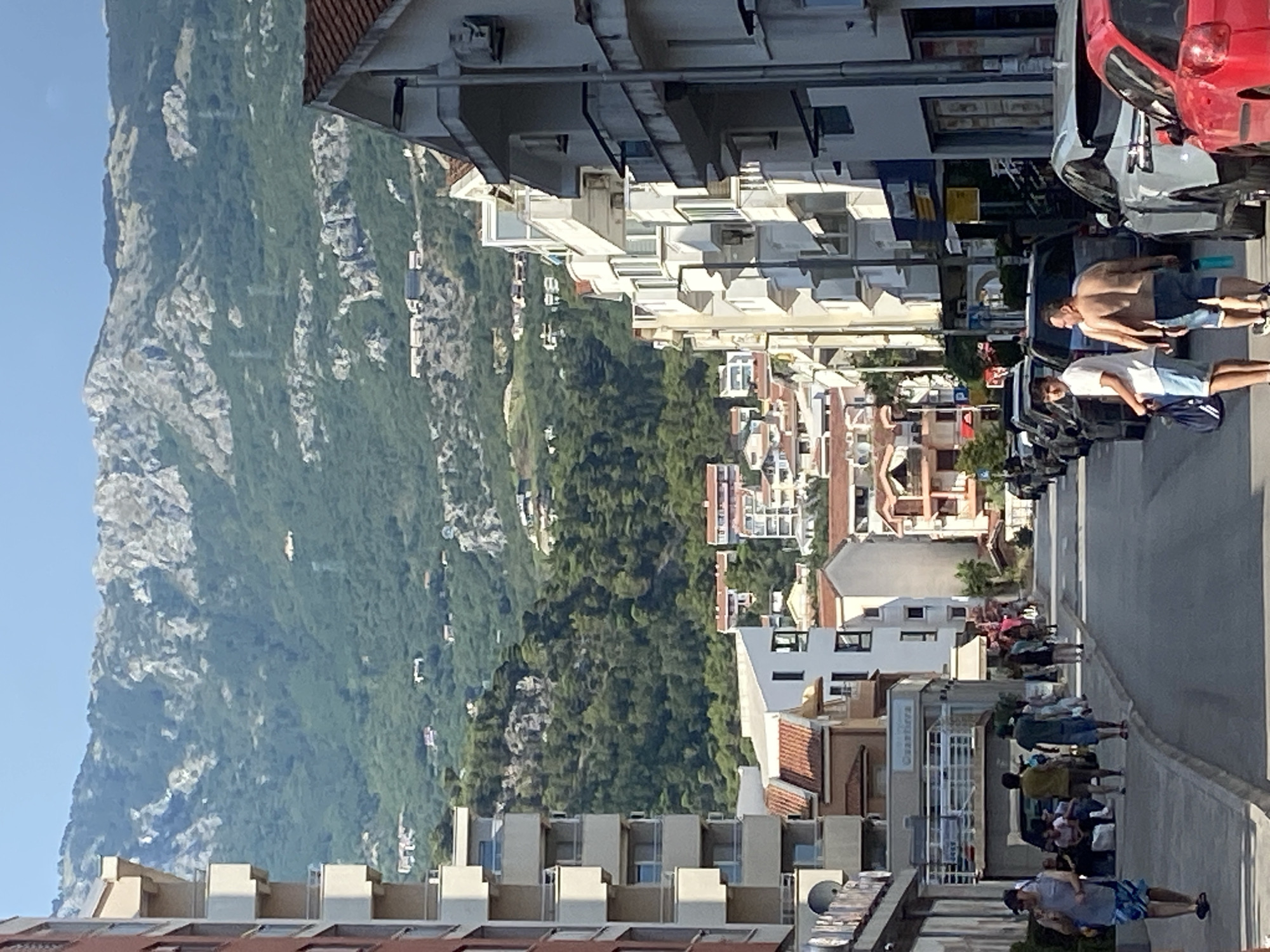 Budva on a summer afternoon — streets, crowds, and mountain views