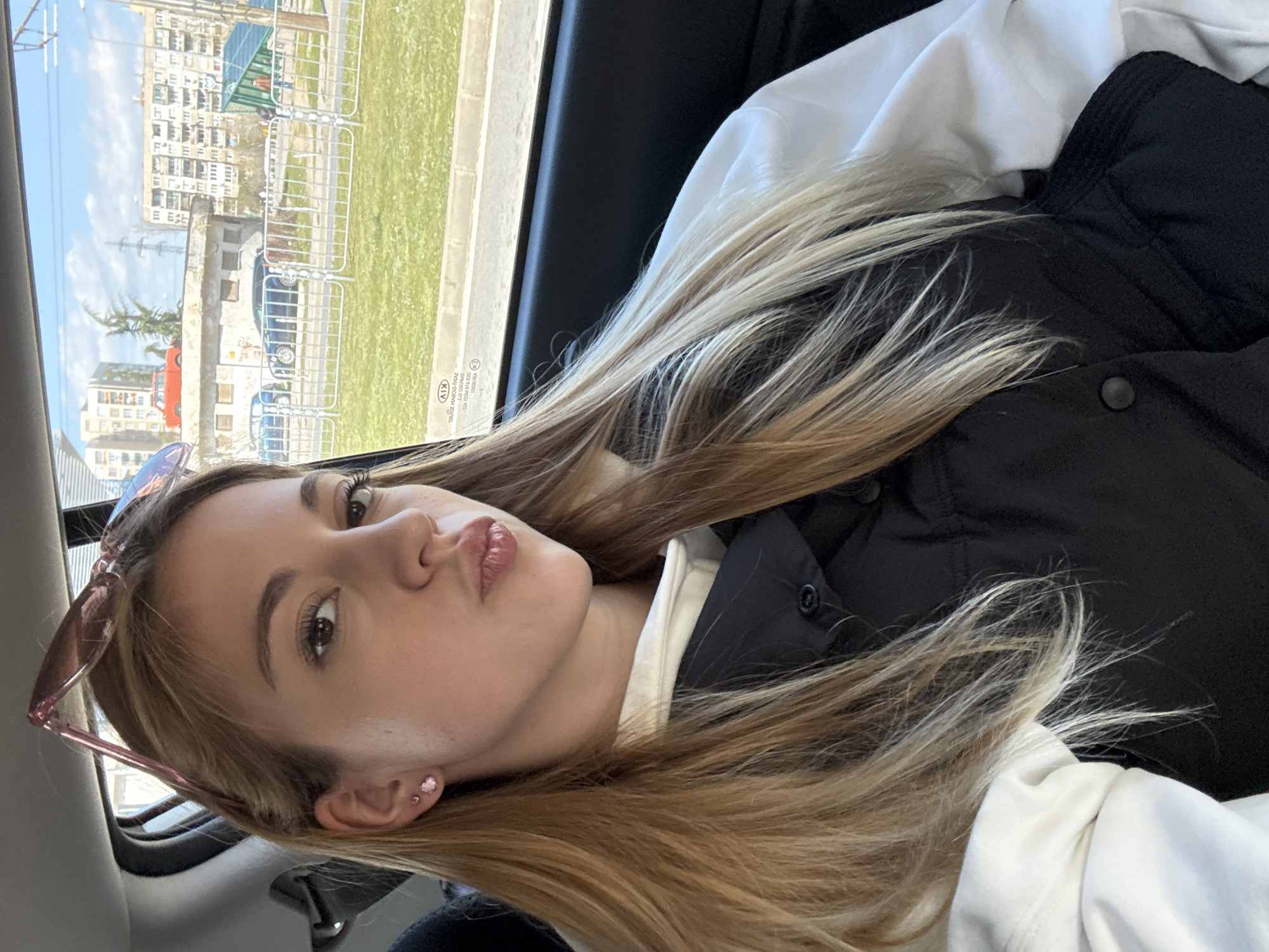 Woman photographed resting, taking selfies in car backseat Sofia