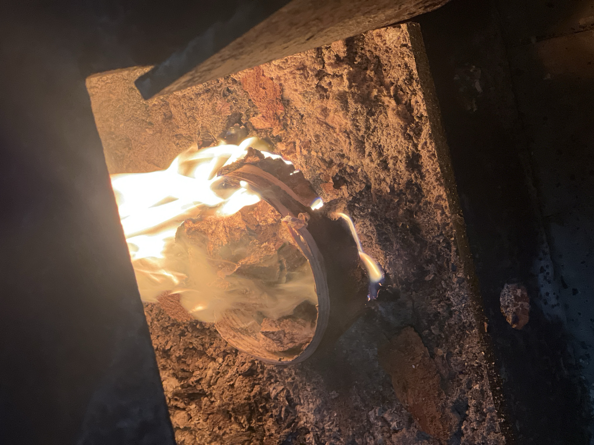 Traveler with suitcase navigates snowy Chaikovsky, tends indoor fire