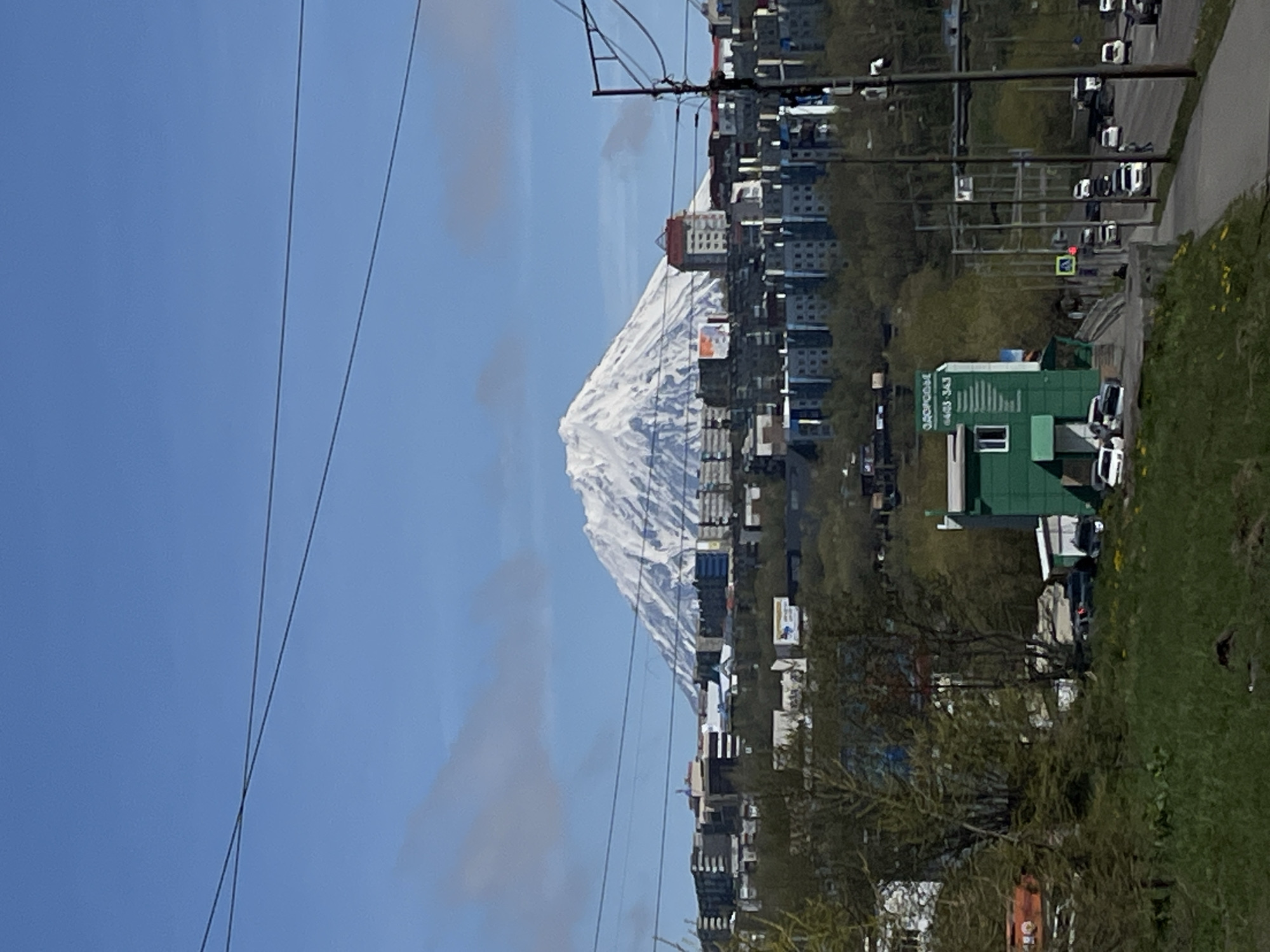 Snow-covered volcanic peak overlooks Petropavlovsk-Kamchatsky cityscape