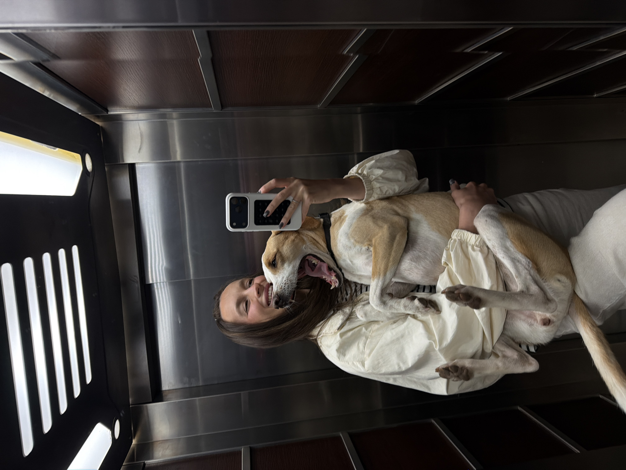 Woman takes selfies with dog in Budva hotel room