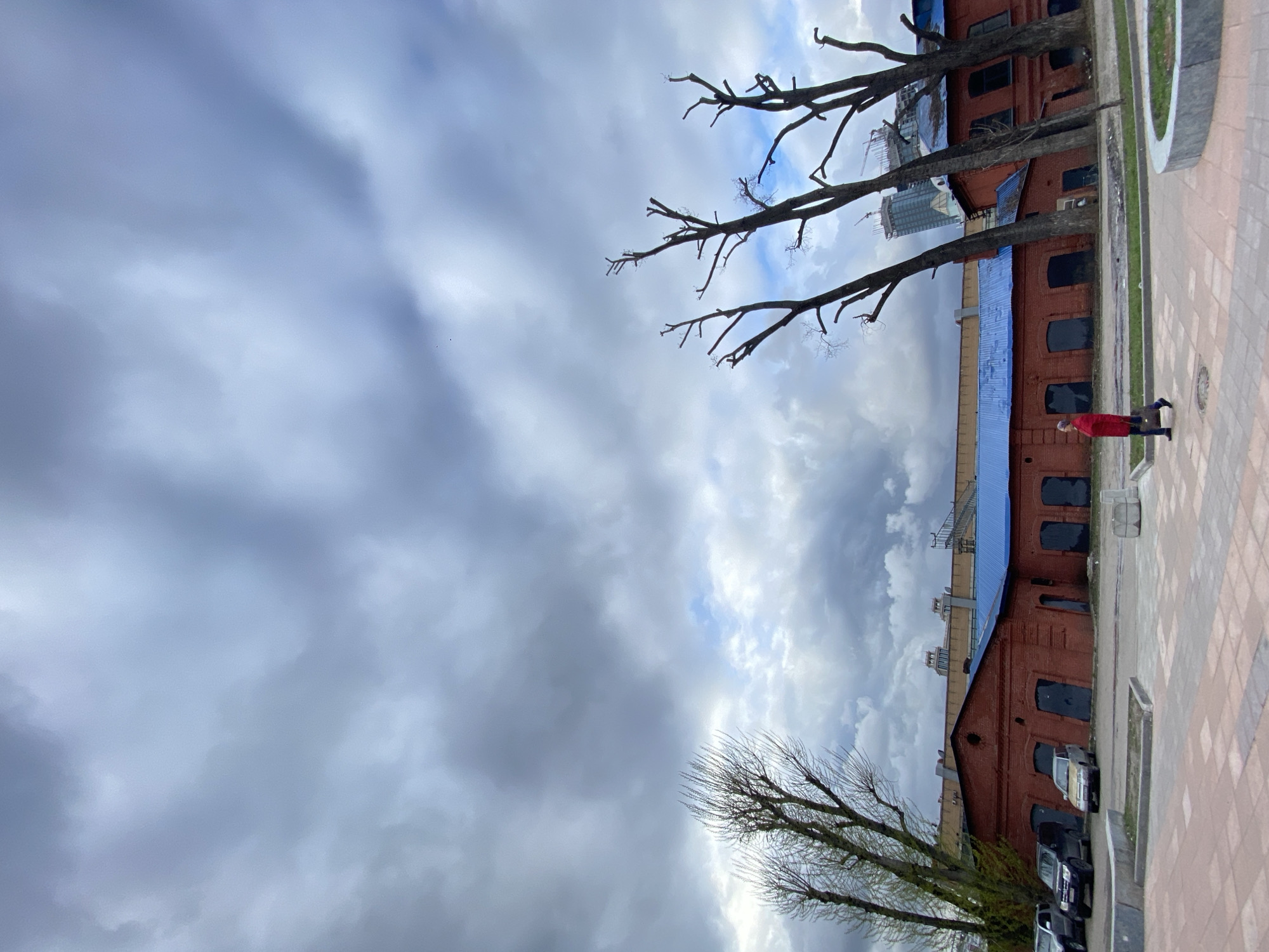 Moscow brick building with blue roof observed under cloudy skies