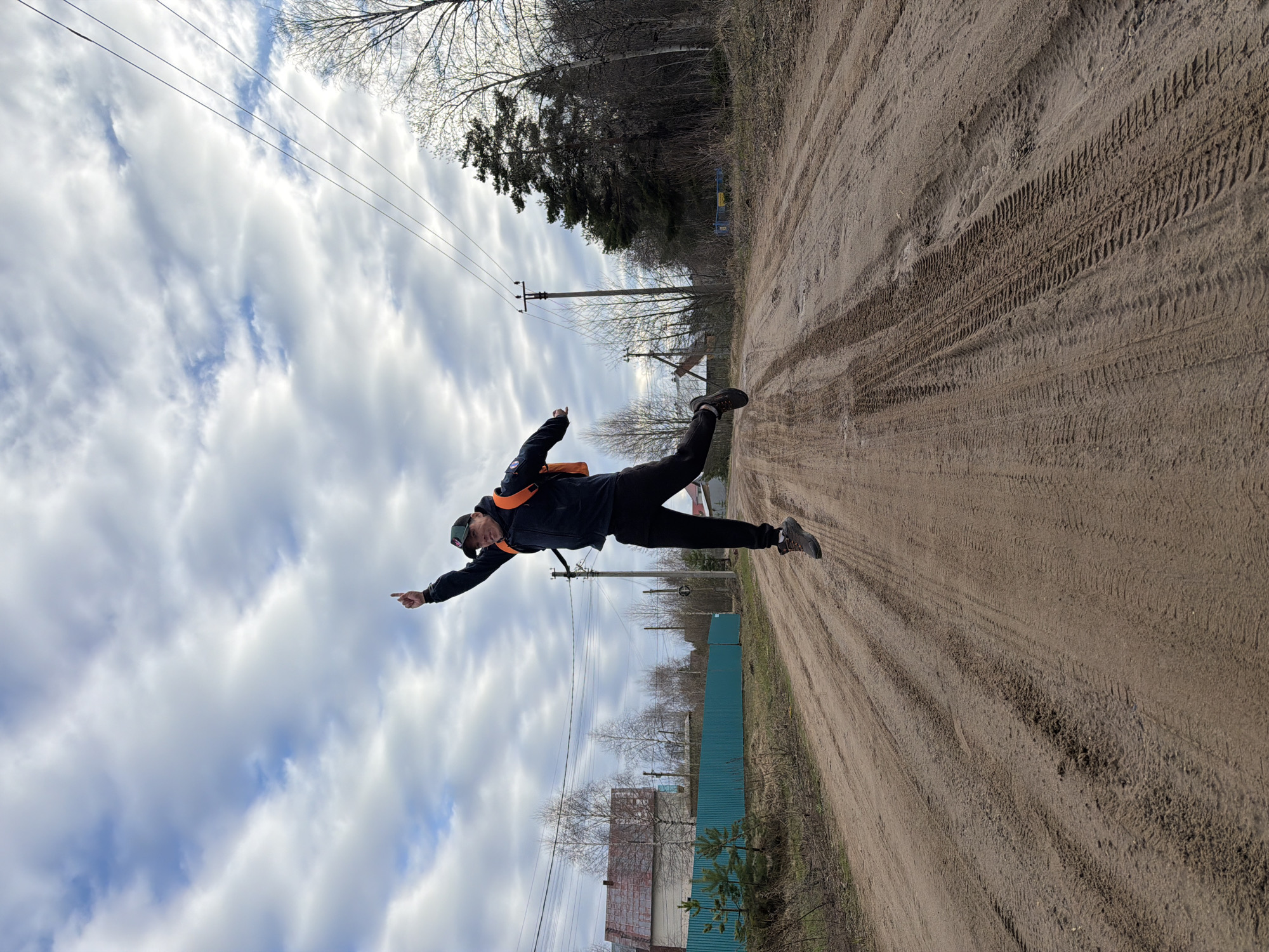 Family walks rural dirt road in Chaikovsky, Russia