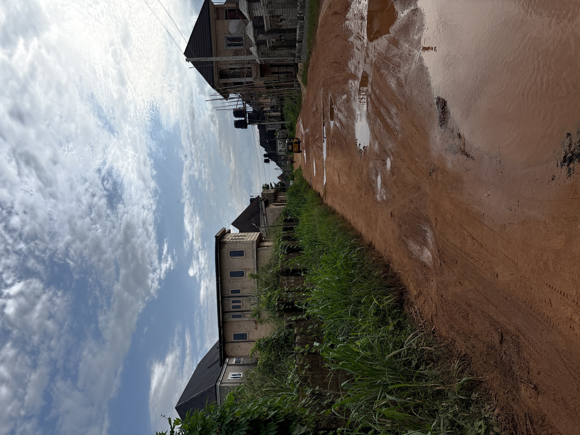 Muddy roads and construction sites in post-rain Obosi, Nigeria