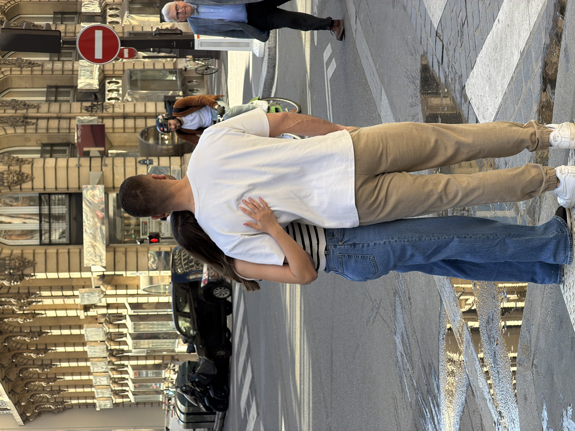 Parisians reflected in storefront windows during midday shopping